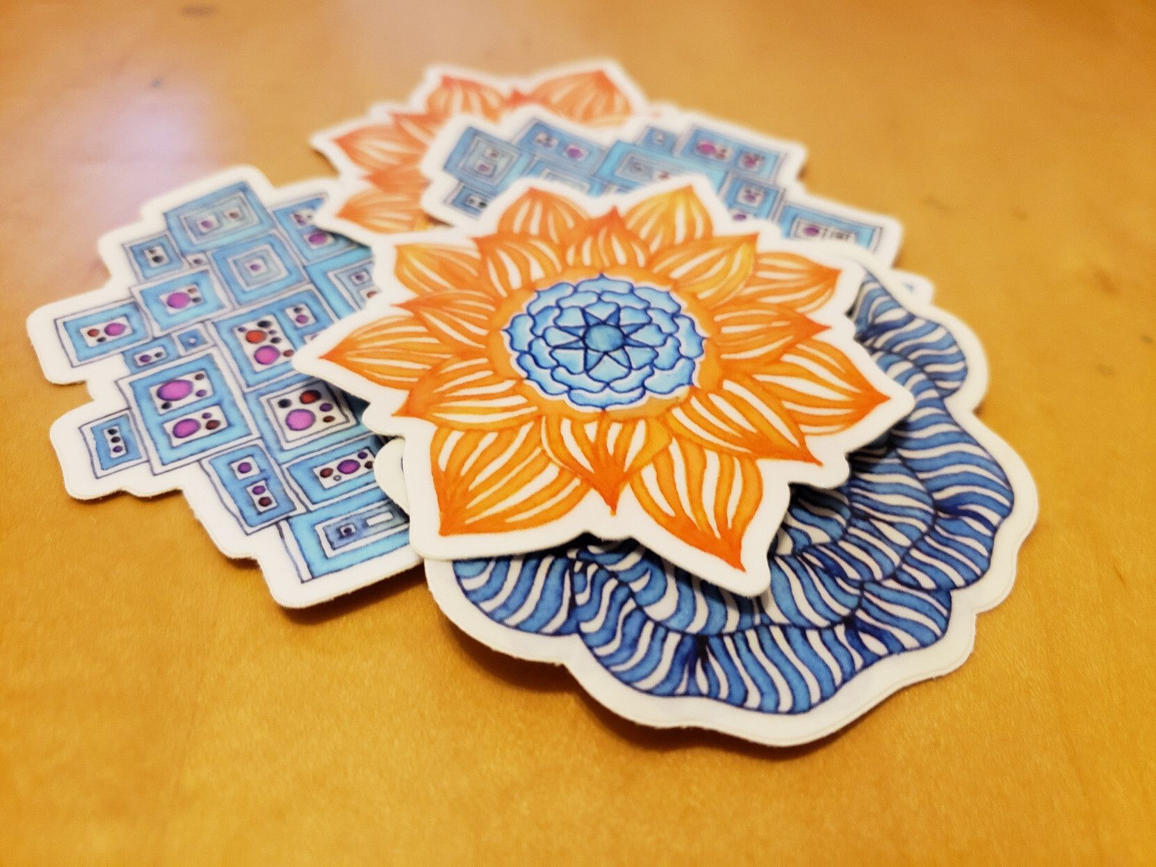 A messy pile of stickers made from my hand drawn artworks.