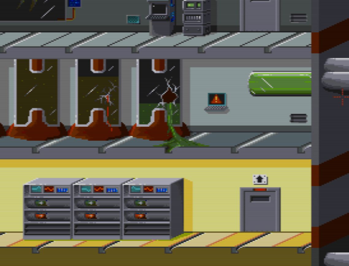 In the shot there is part of room 21, this room is on 3 levels.
In the top level there something unclear on the left, a terminal and an electronic device, and a door on the right.
In the mid level there are 3 glass cylinders, the right one is broken with some green fluid on the ground. There is also a small terminal and another horizontal container with greenish fluids inside.
In the lower level there are some devices with small monitors on them and on the right there is a door.