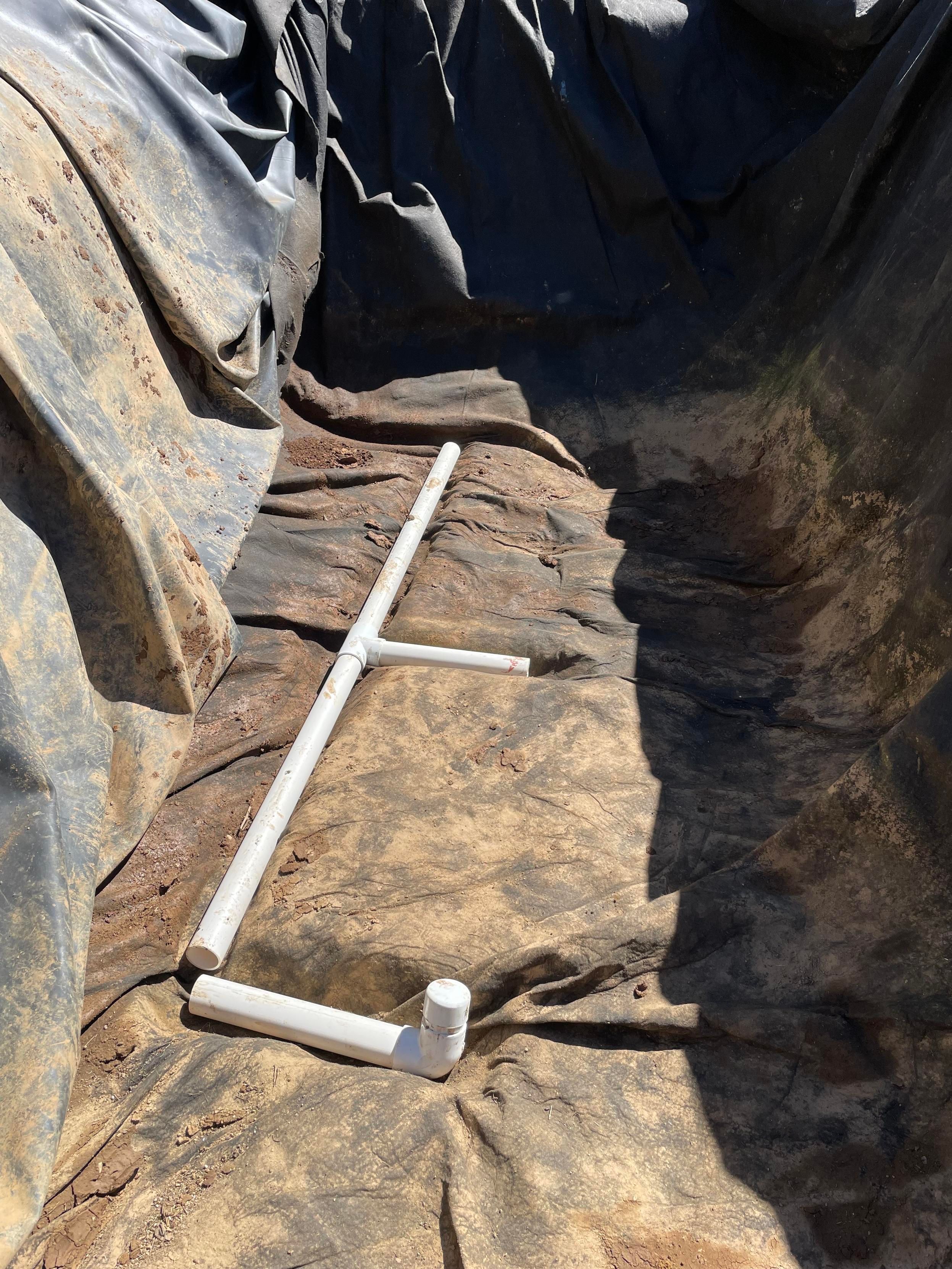 the fabric put back down into the trenches and the pipe set in to be sure it was ok.