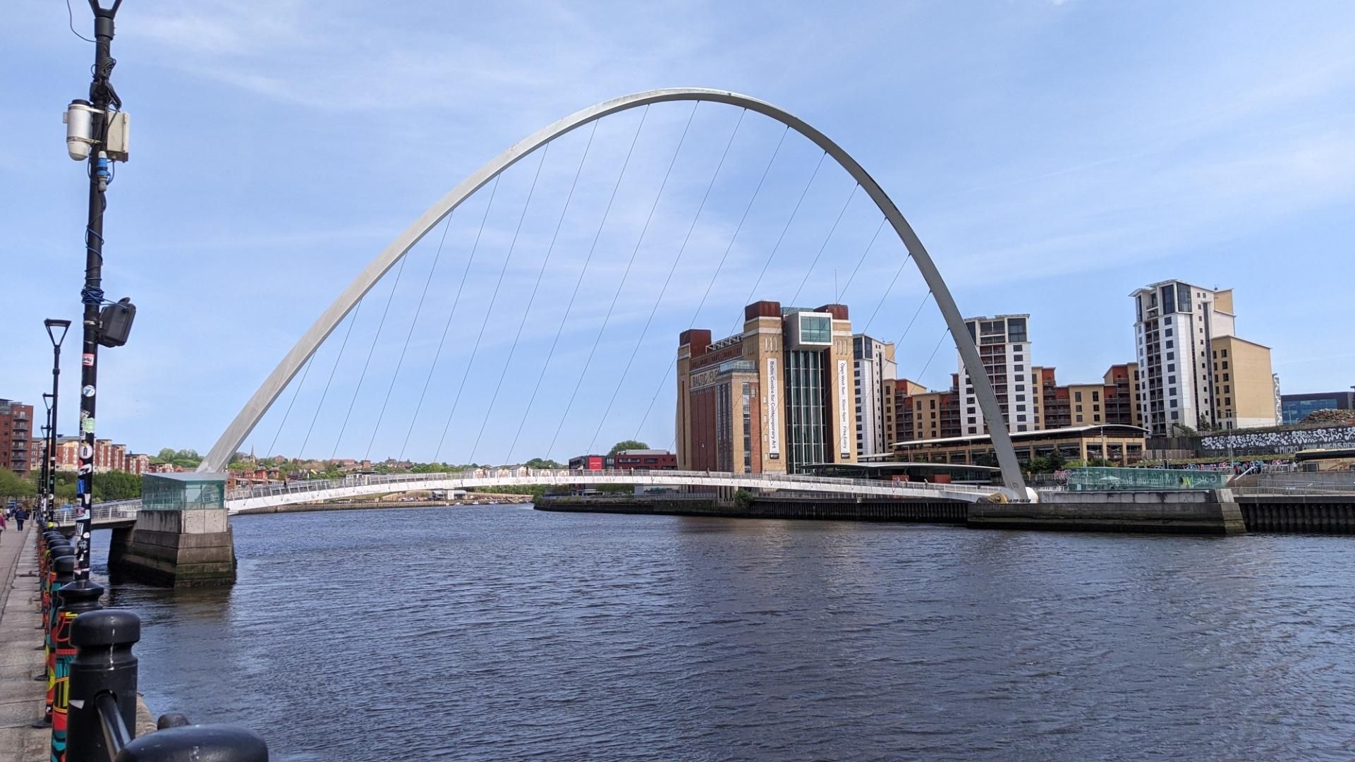 The millennium one bridge: an arched pathway for pedestrians & cyclists, tied with steel rope to a concrete arch above