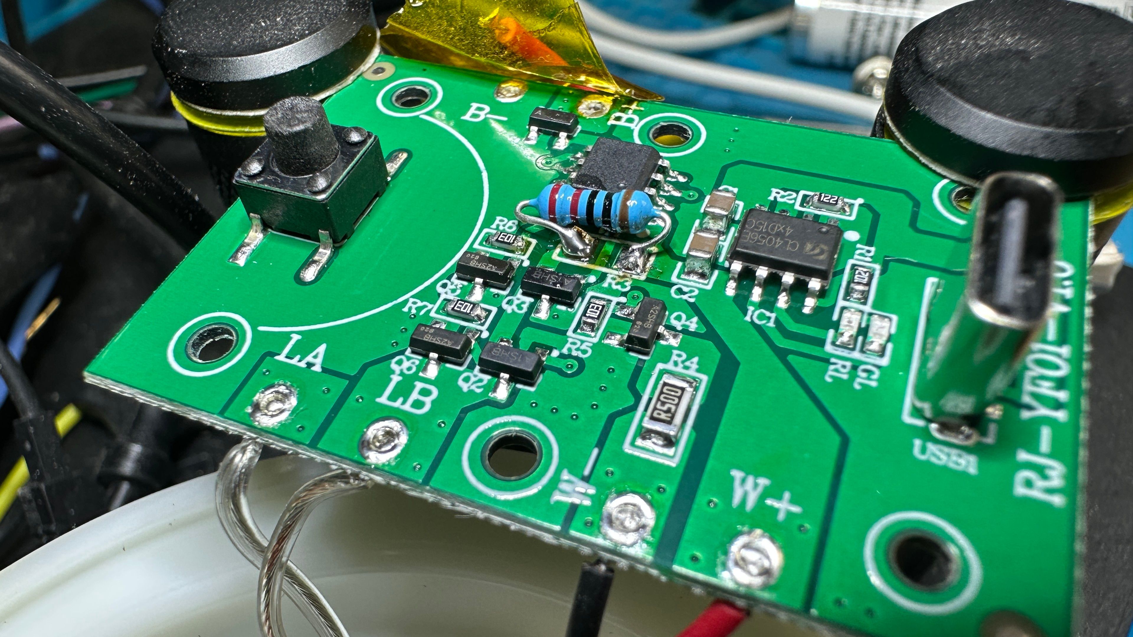 Pcb with all surface mount parts except for one blue resistor 