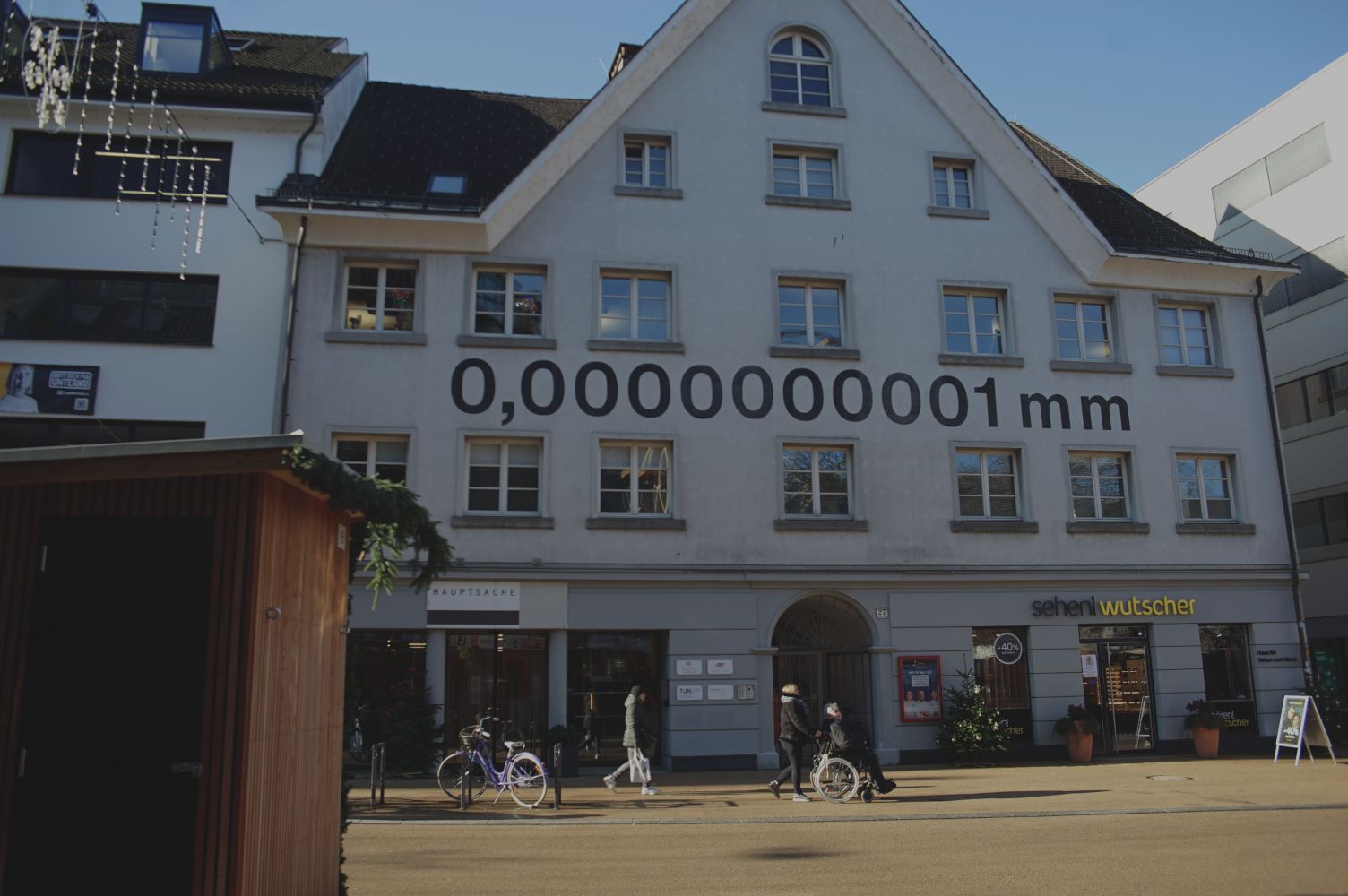 Heinz Gappmayr installation that writes 0.0000000001mm in large on the side of a building.