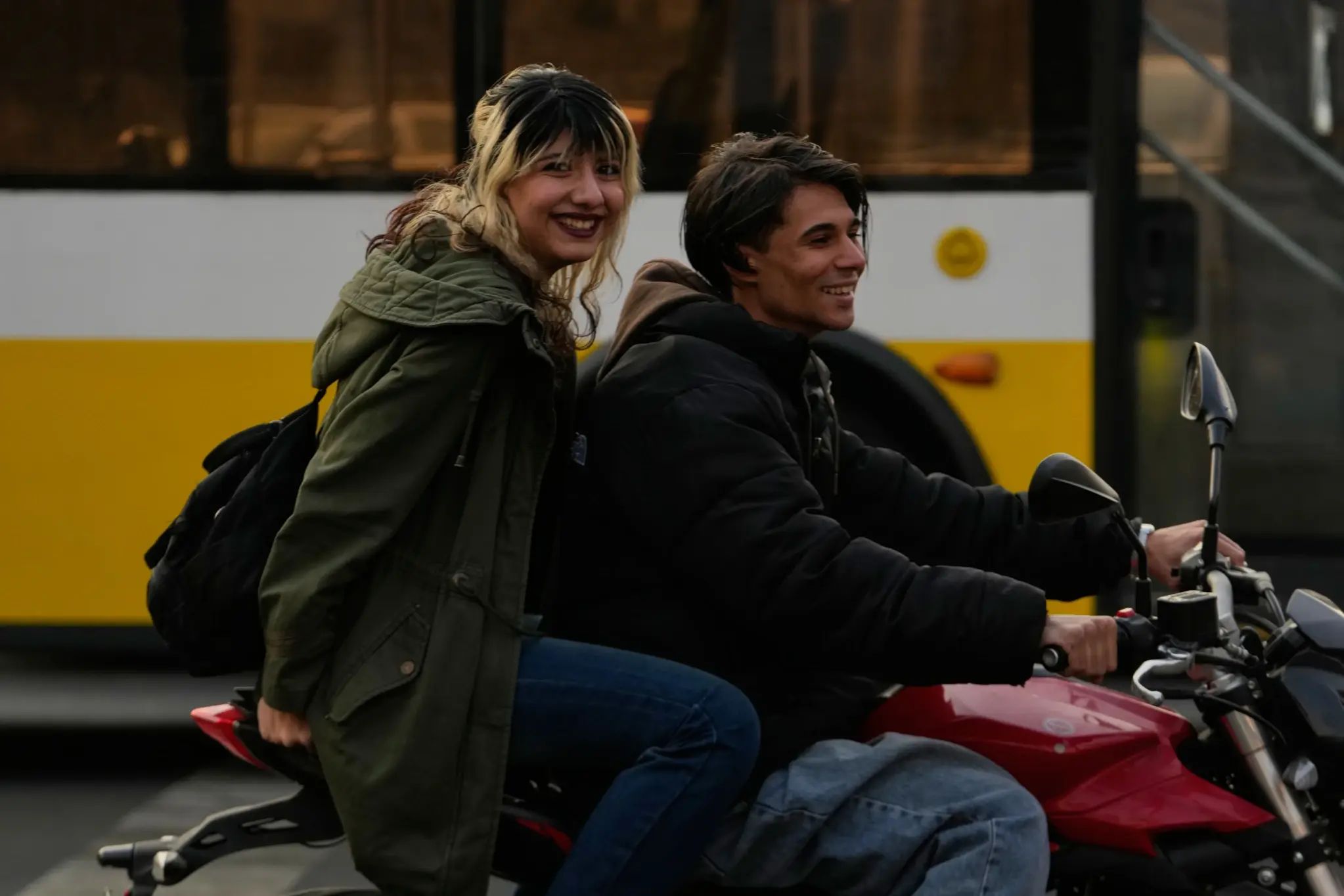 A man and a woman ride a motorbike in northern Tehran, Iran, Thursday, Nov. 20, 2025