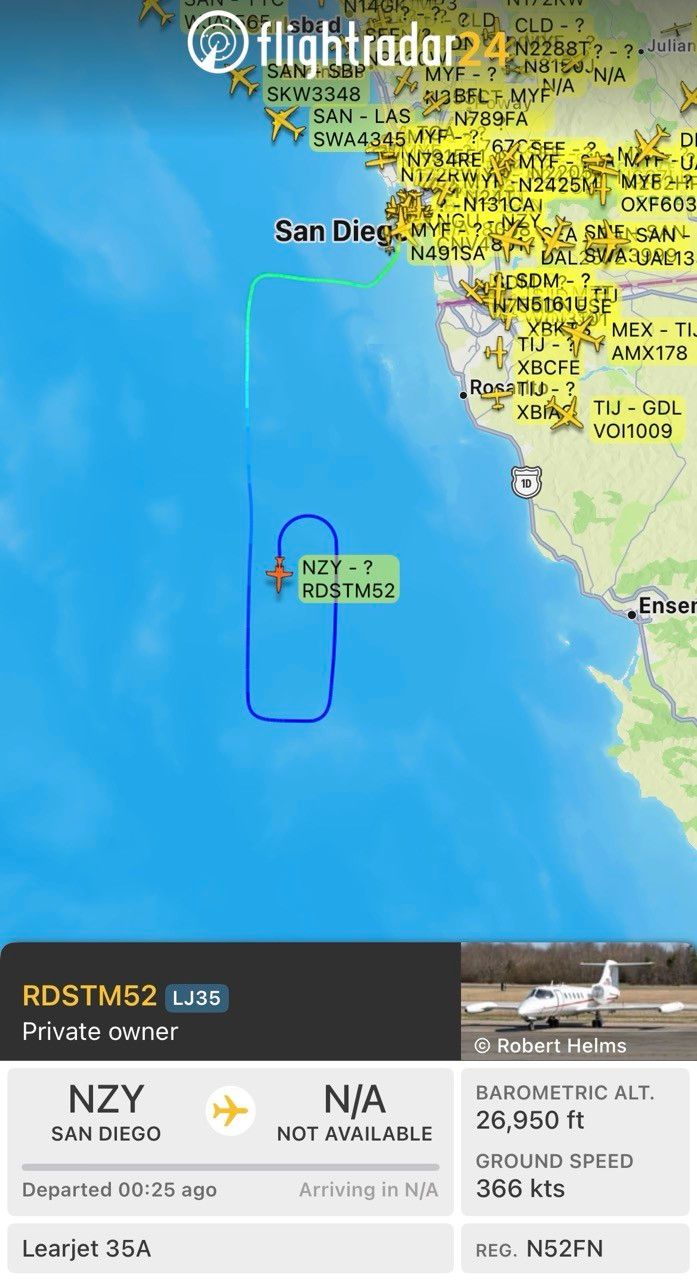 A screenshot from the Flightradar24 app showing a Lear jet that has left San Diego going south over the ocean and then turning around to head north again and then turning around once more to head south. 