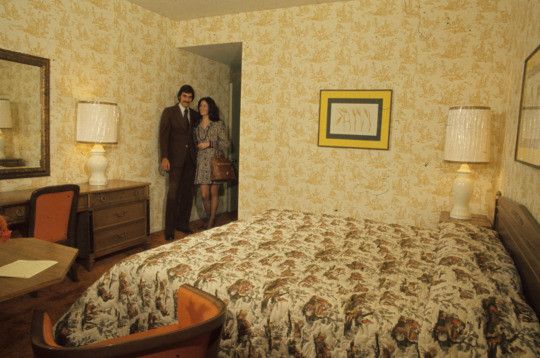 vintage shot of a motel room with a couple in the entrance