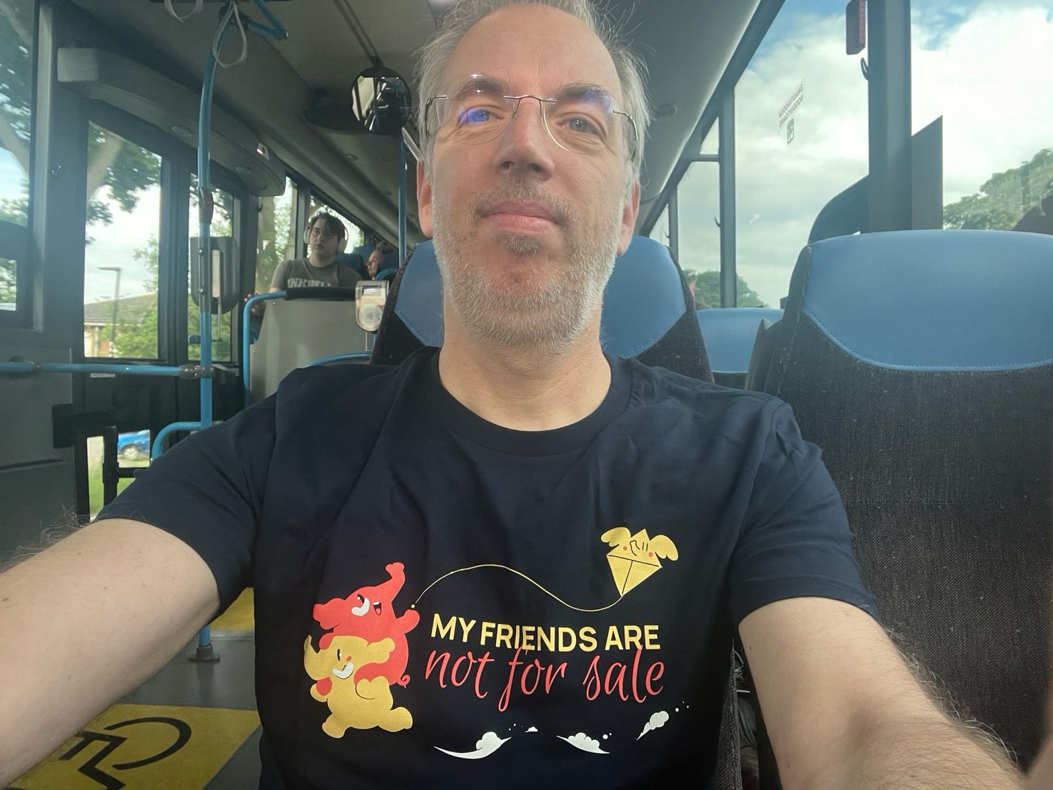 Selfie in the bus wearing the blueish mastodon shirt that states “my friends are not for sale”.