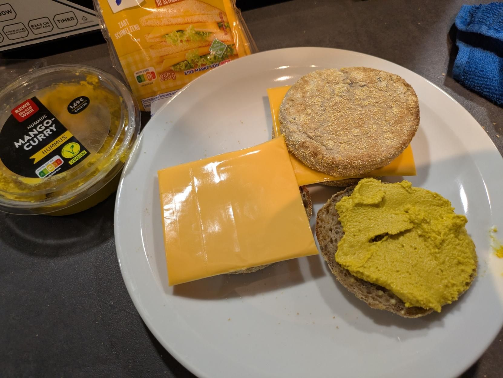 whole wheat english bread muffins with mango curry hummus and kraft cheese slices