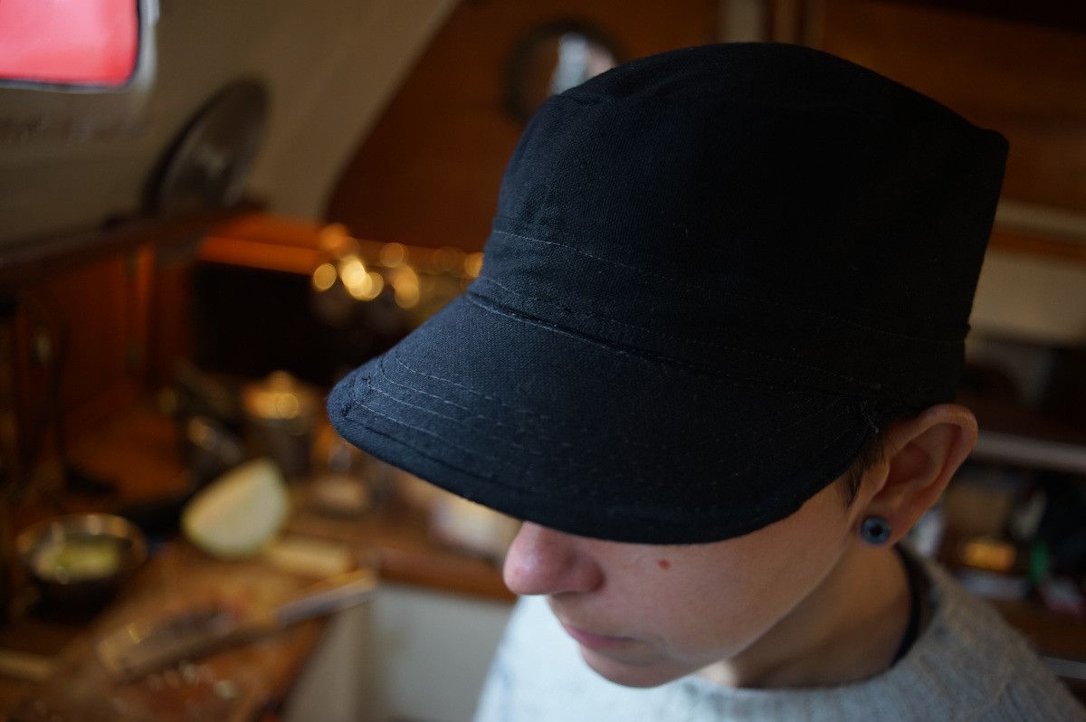 rek is wearing a black cap they just put together out of 12 oz cotton canvas. The angle shows the topside of the cap.