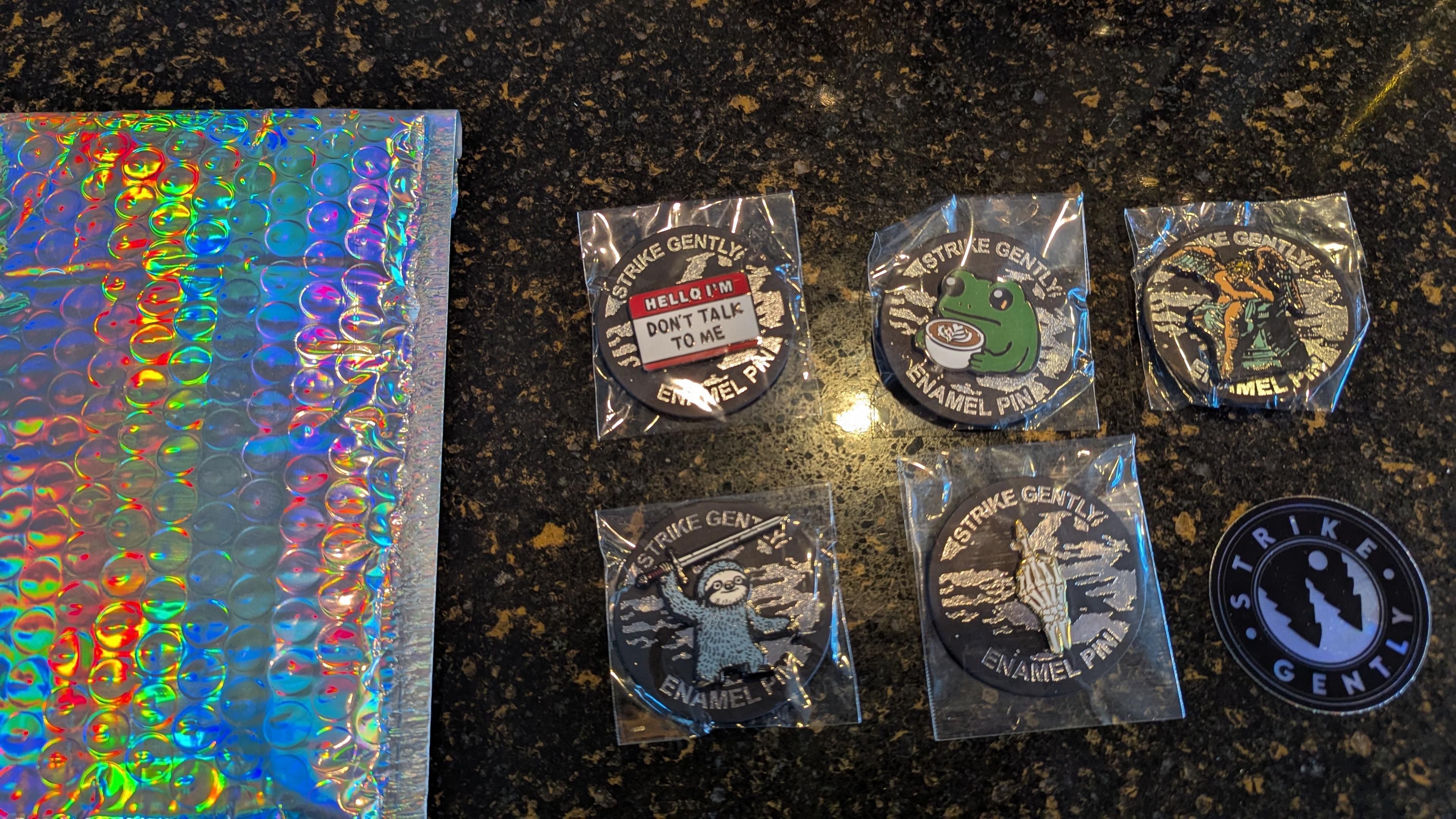 Picture of some enamel pins from #StrikeGently and the amazing packaging it was shipped in