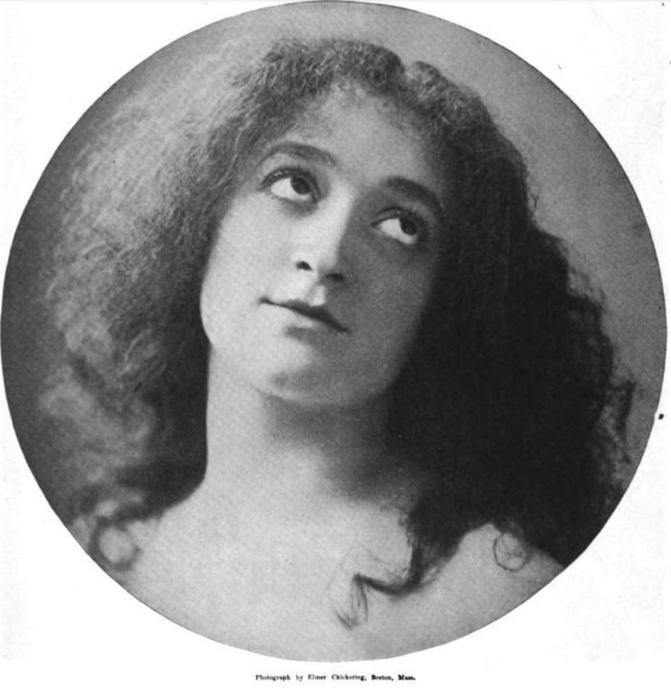 Felicia Barasco, a young white woman with loose dark hair, in a round frame; she has her eyes cast upward