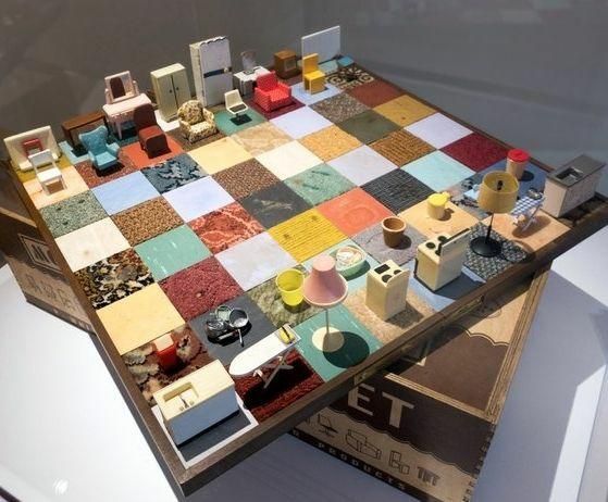 A chessboard, multicolored, but created with household objects and appliances