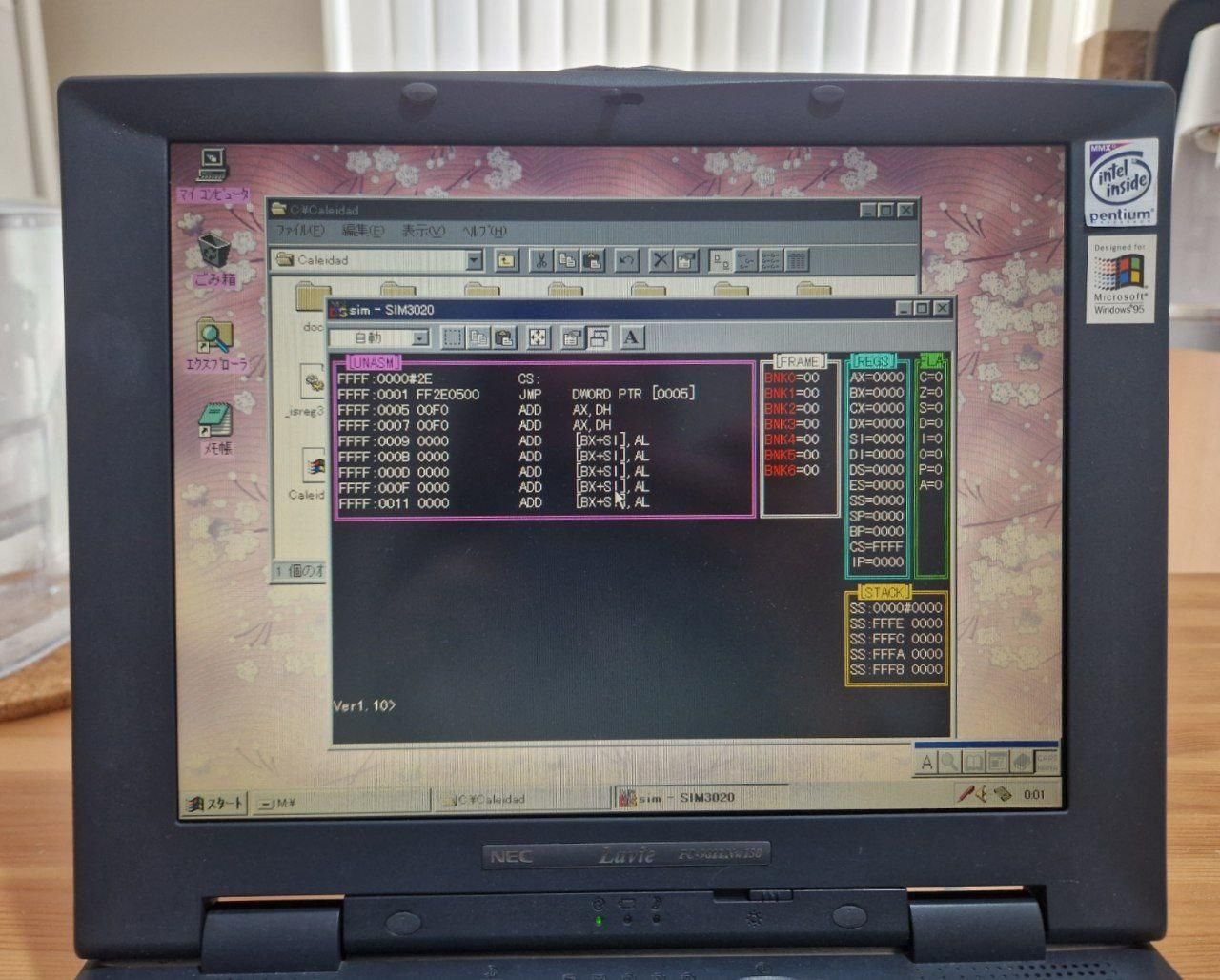 A photo of an old laptop screen, showing Windows 95 running. A DOS session is showing the state of the CPU, memory and registers of an emulated Casio Caleid computer
