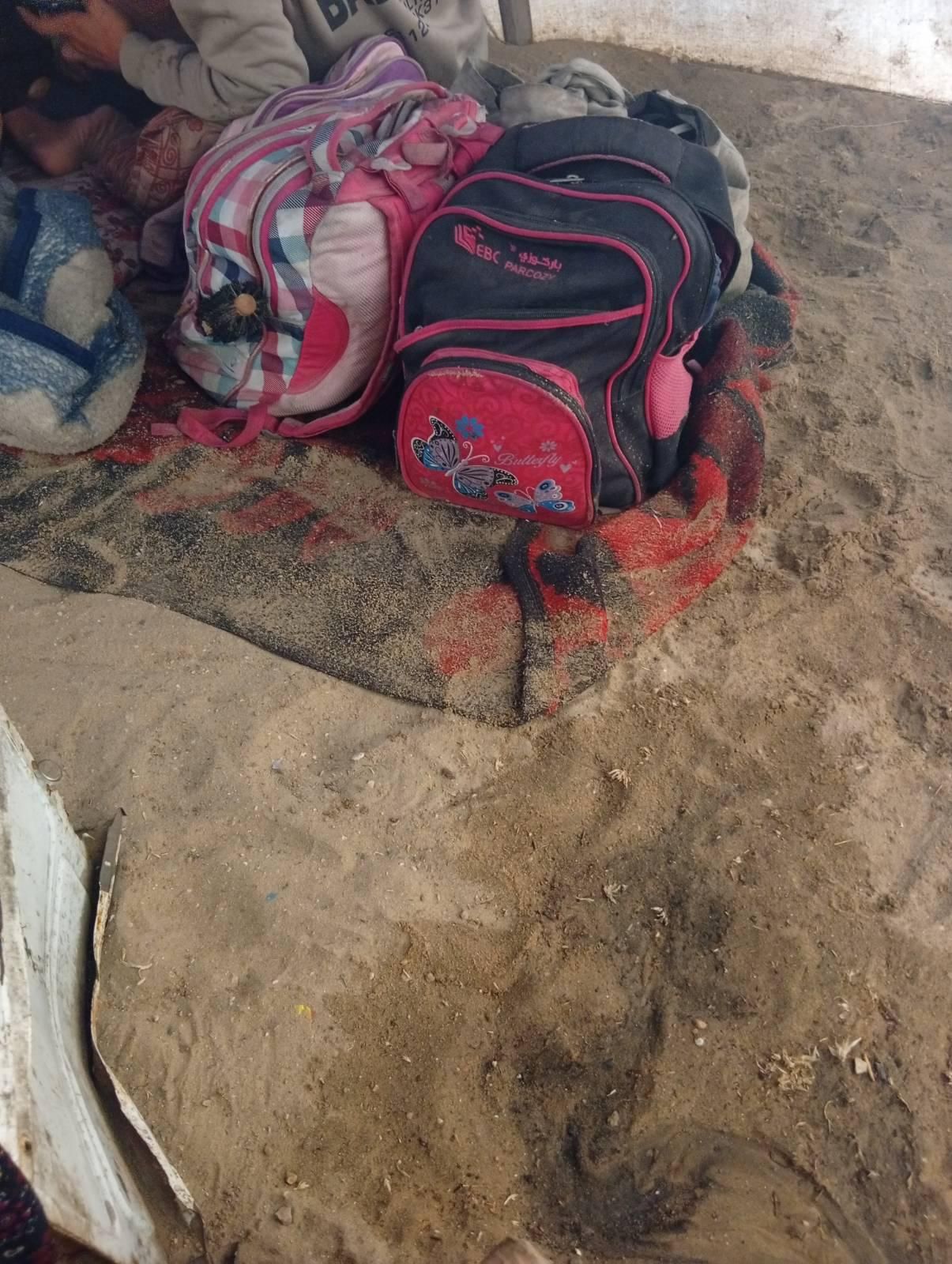 Our bags on the wet sand under the tent