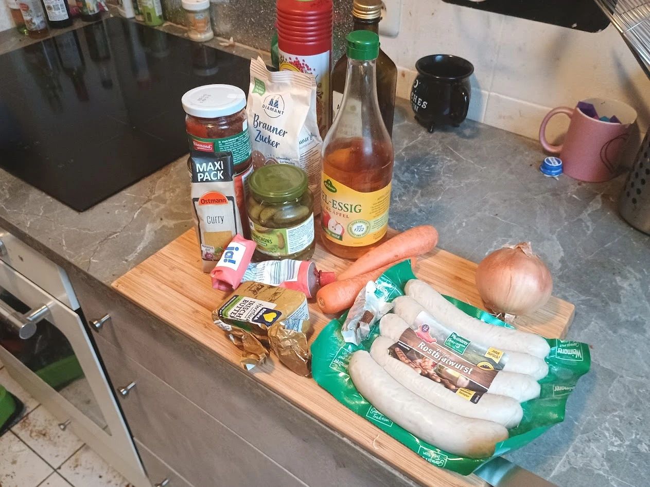 Ingredients on a cutting board for Currywurst