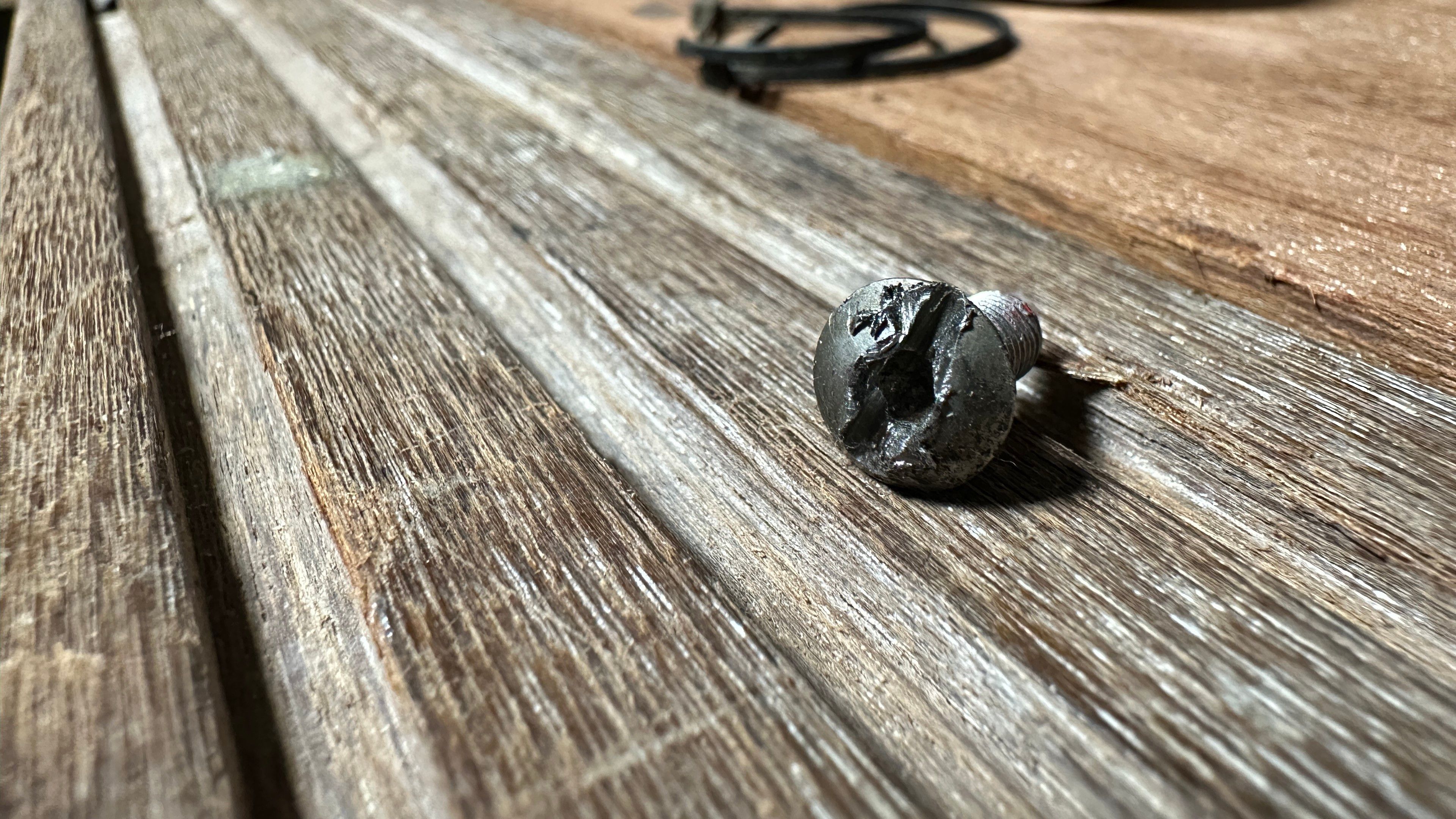 Stripped 3mm hex with a slot cut across the head to allow it to be unscrewed with a flat head driver. 