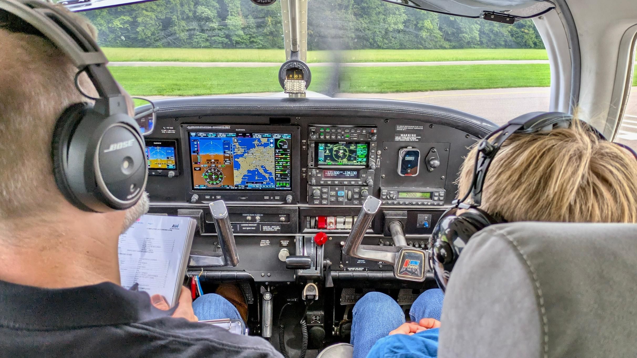 My godchild and me sitting in the Piper Archer (on ground).