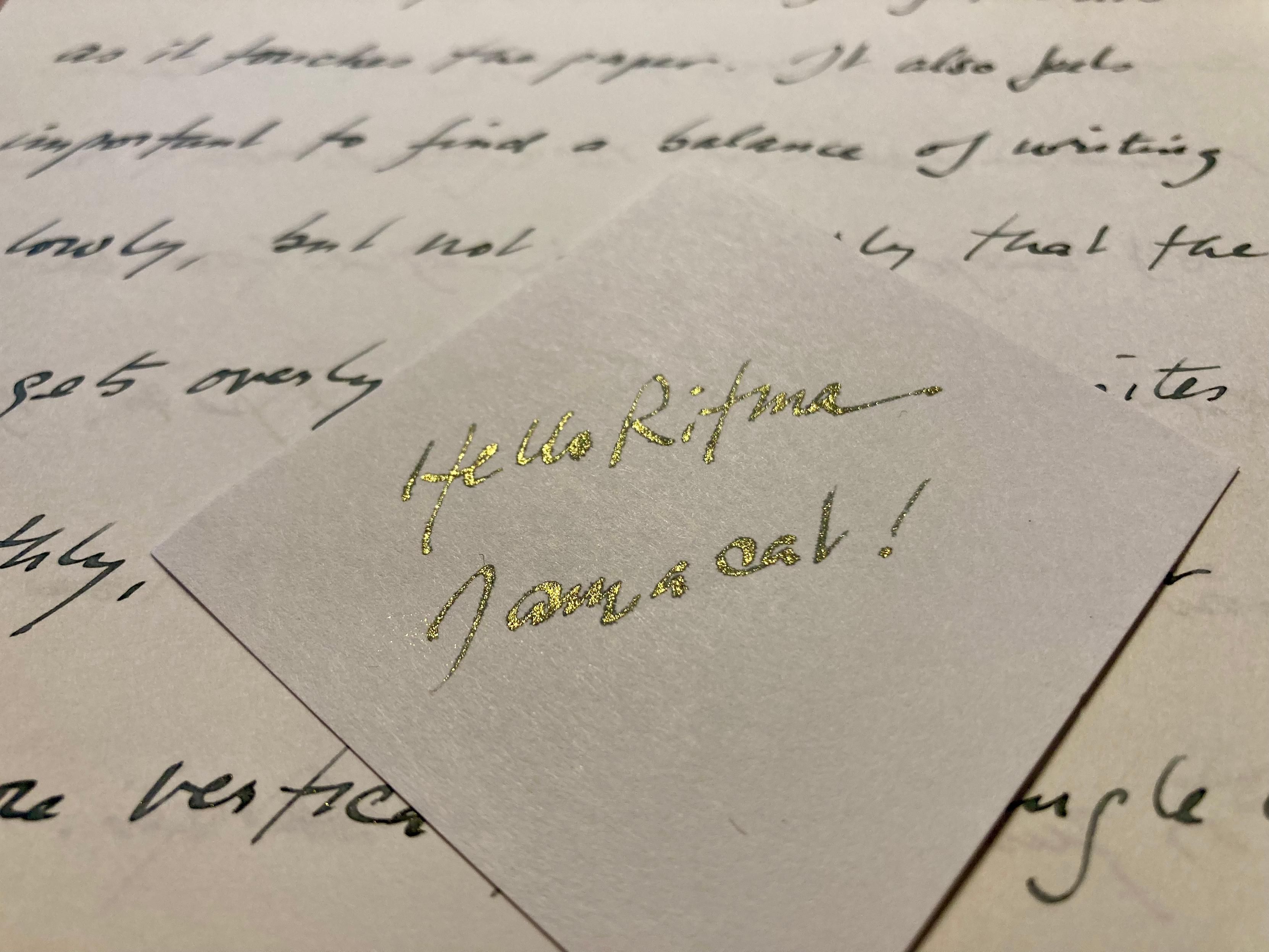This photo shows handwriting on two types of paper. In the center of the page the ink's tiny metallic flakes can be seem to shimmer, but in the background the same ink on different paper shows little shimmer effect.