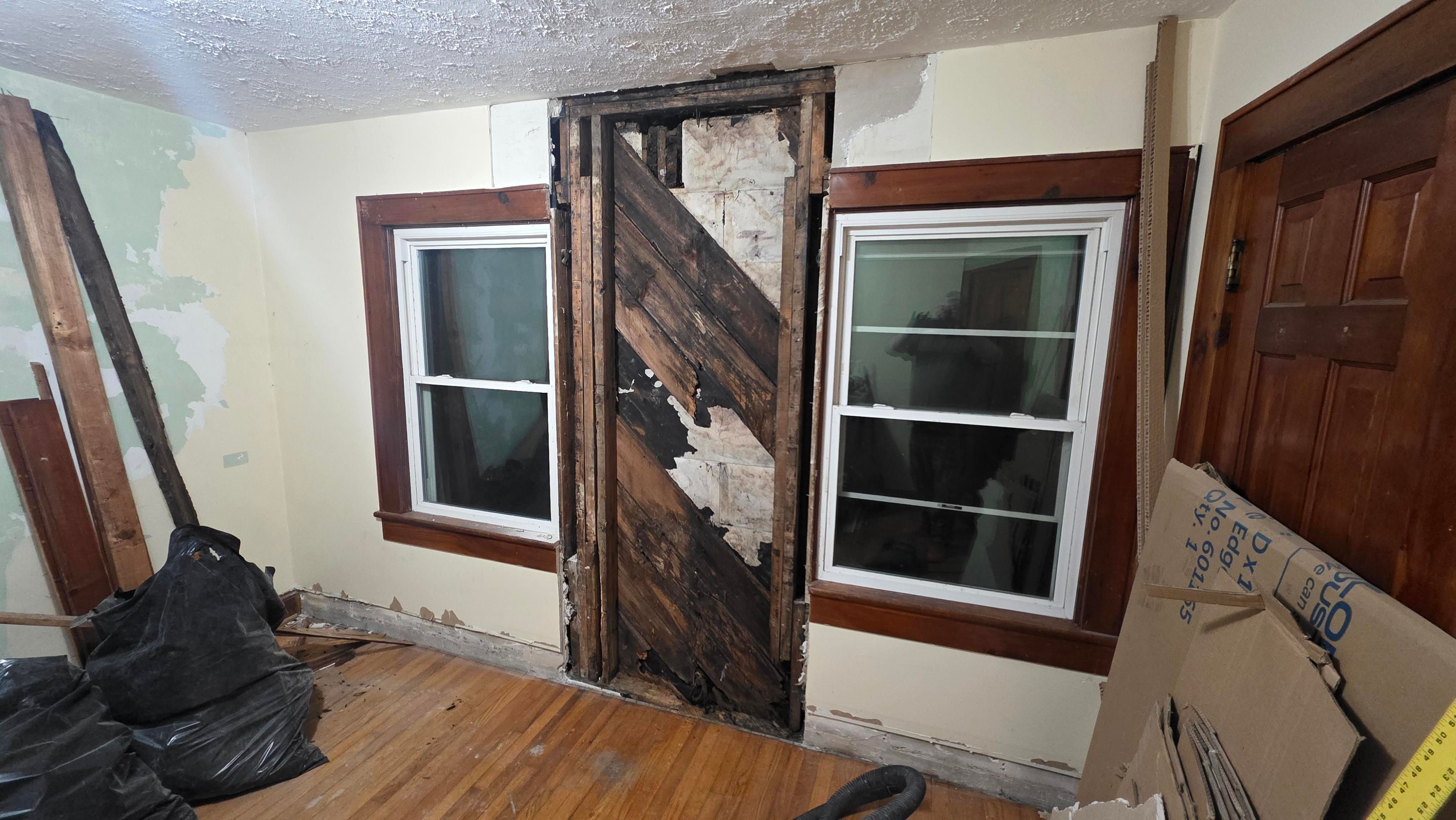 Part of a wall demolished to the siding after years of water damage