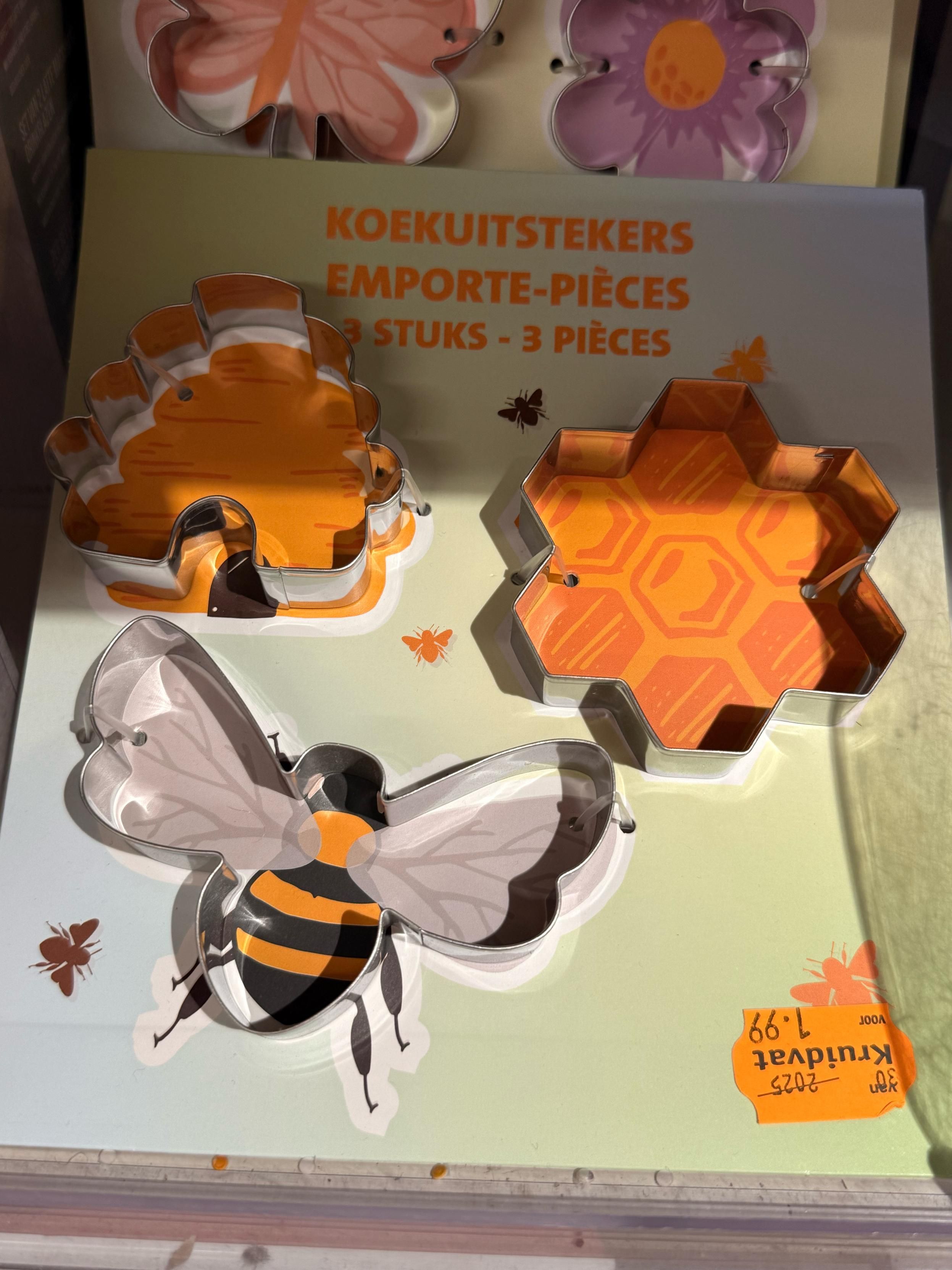 Cookie cutters in the shape of a bee, a beehive and a honeycomb 