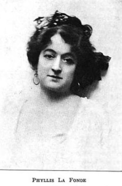 Phyllis La Fonde, from a publication in the 1910s; a white woman with dark curly hair, wearing a light top with a deep square neckline