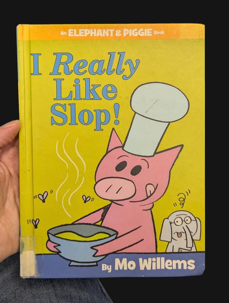 A children's book by Mo Willems titled "I Really Like Slop!", with an illustration of a pig in a chef's hat holding a bowl of green goop with flies around it and an elephant looking disgusted in the background