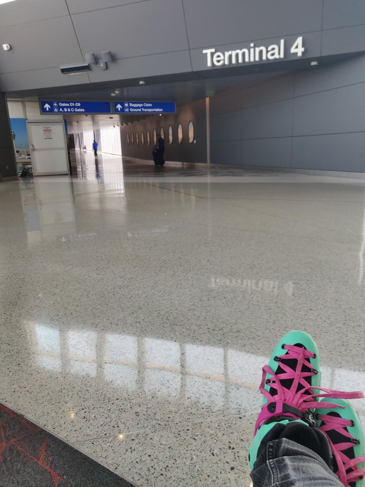 me wearing inline skates in an airport, area labelled terminal 4