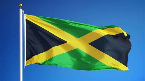 The Jamaican flag--a gold X with black on the sides and green on the top & bottom--flying against a blue sky