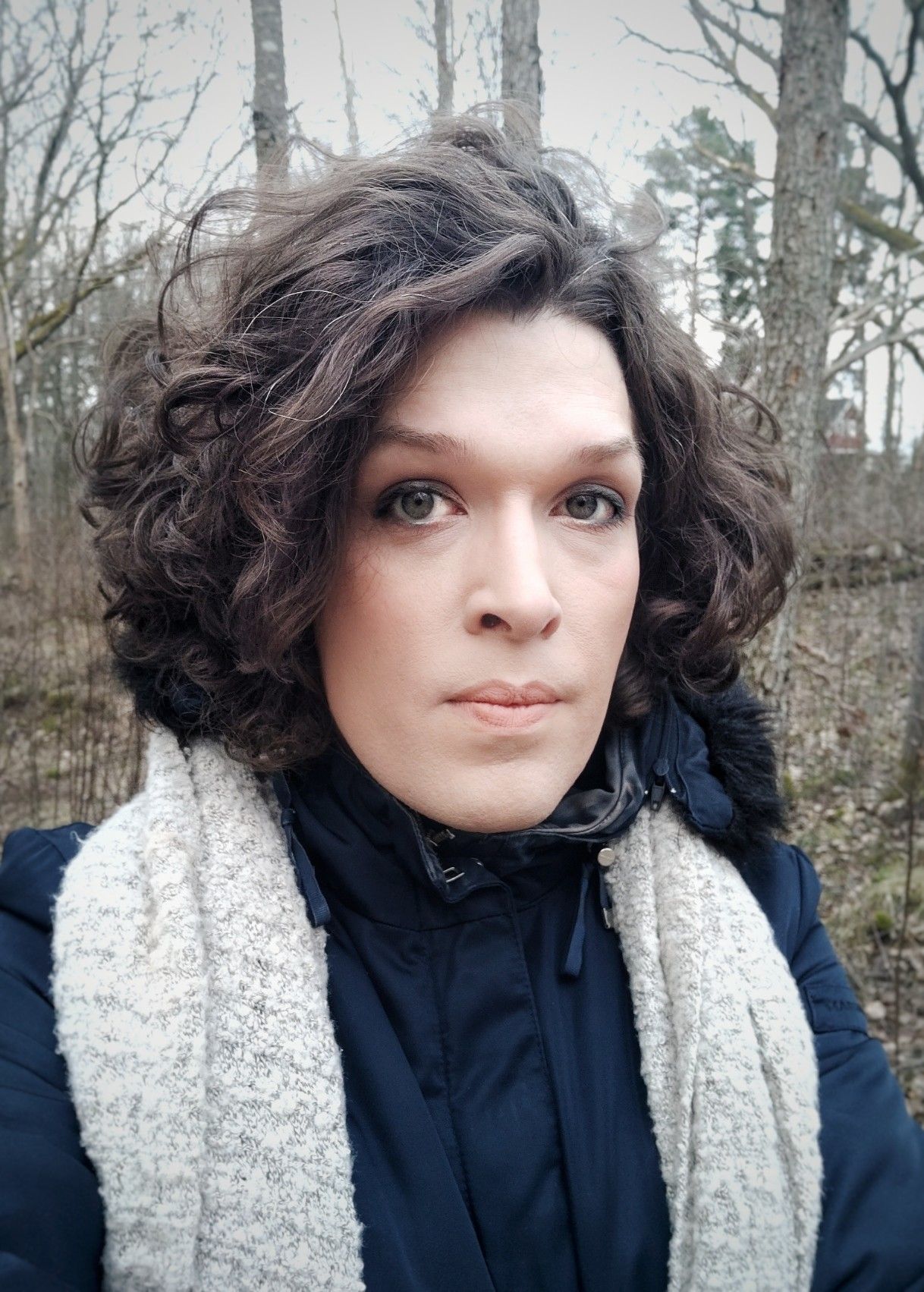 me in a blue jacket on the leafless forest, looking glum