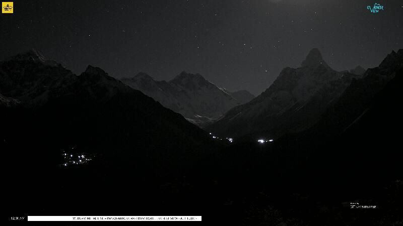 A nighttime webcam photo of a mountain range. The sky is clear and stars are visible.

Mountains visible in the for, from left:

- Taboche (6,500 meters/21,325 feet)
- Mount Everest (8,848 meters/29,032 feet)
- Lhotse (8,516 meters/27,939 feet)
- Ama Dablam (6,814 meters/22,355 feet)