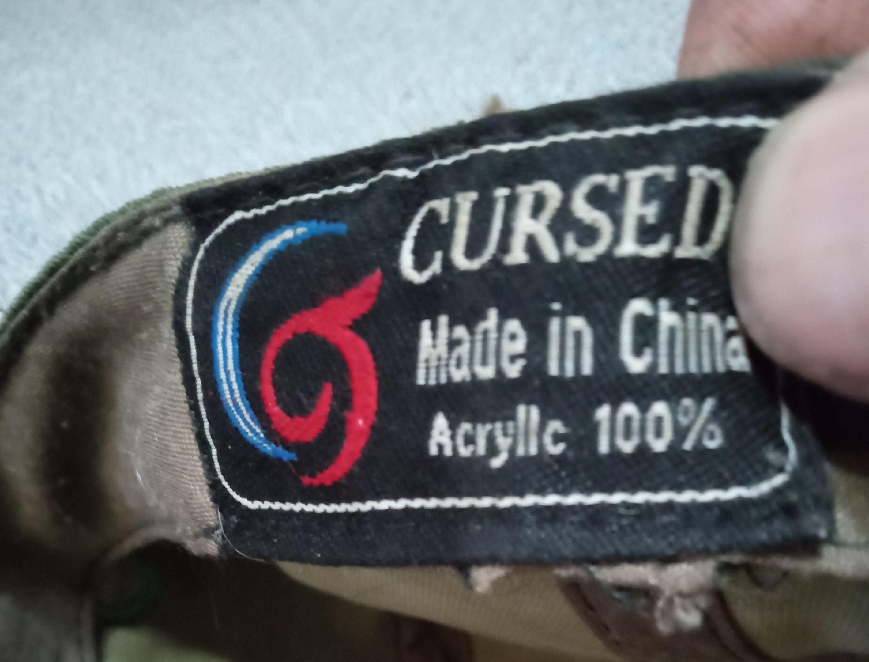 Tag/label under back of hat.

"CURSED"

Made in China
Acrilic 100%