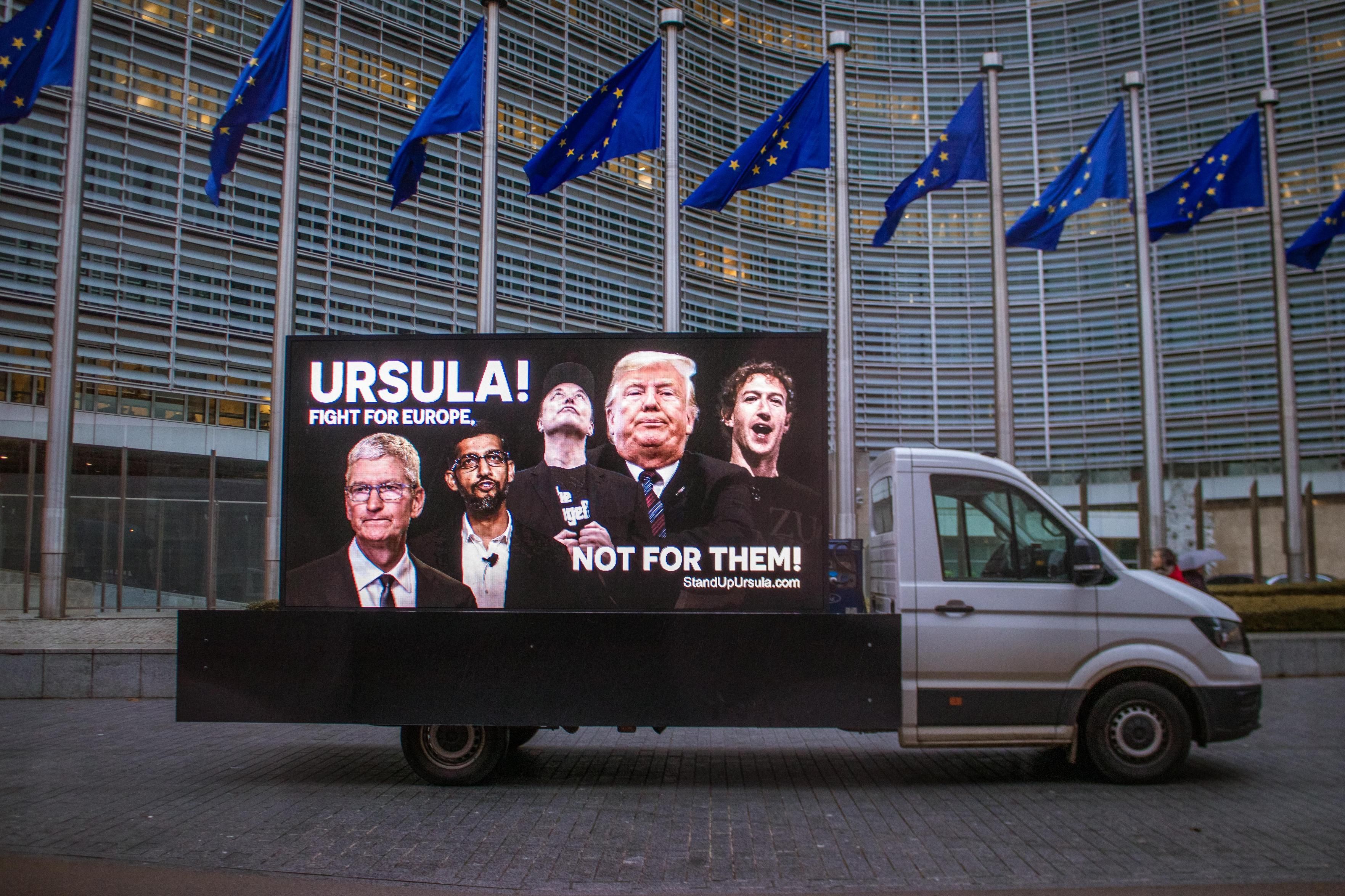 Billboard in front of the European Commission's building. The banner says: "Ursula! Fight for Europe, not for them!", referring to Trump and Big Tech.