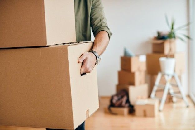 Stock photo of a person moving boxes