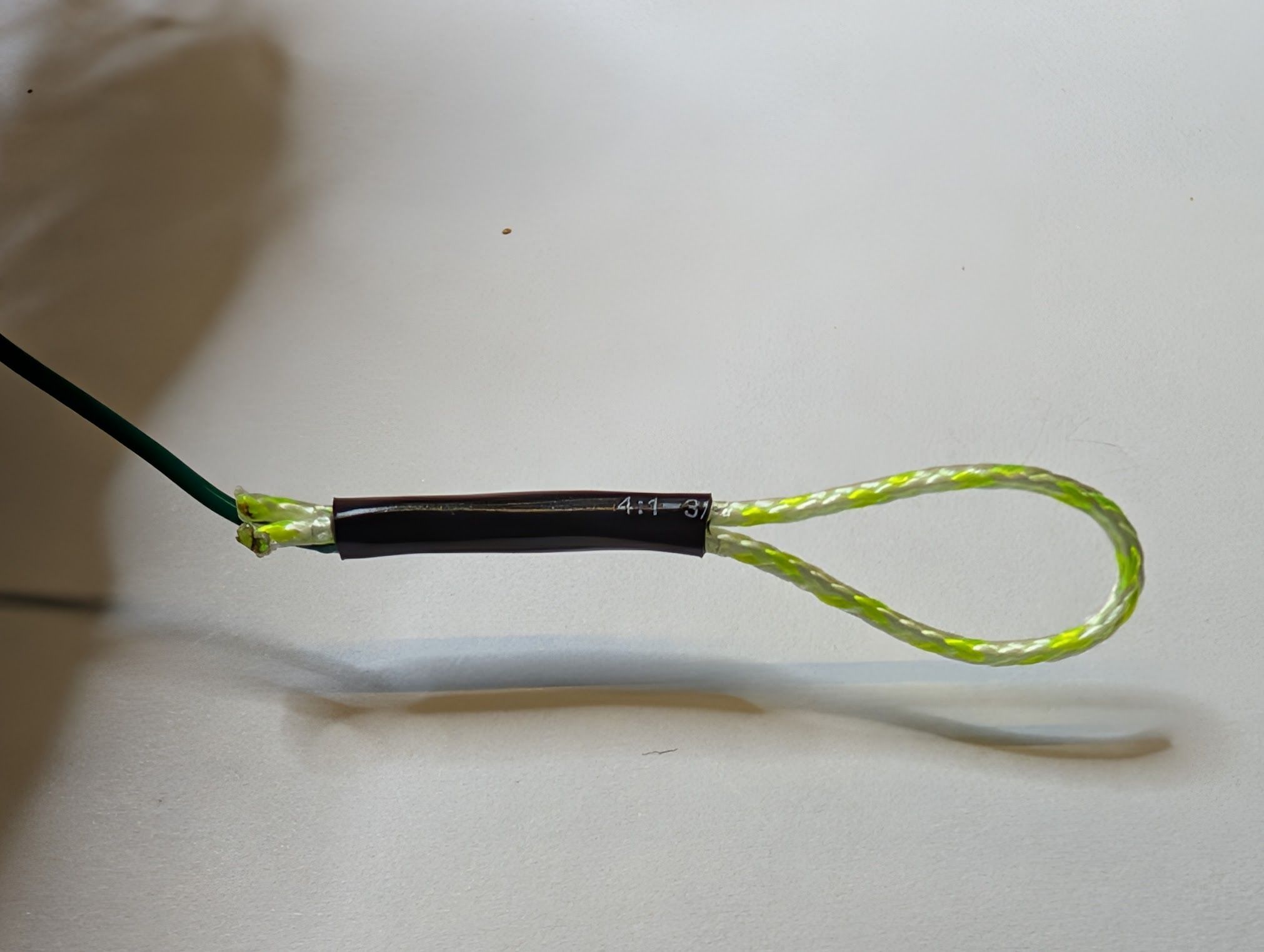 Shrunk tubing after heat applied, holding wire and loop together