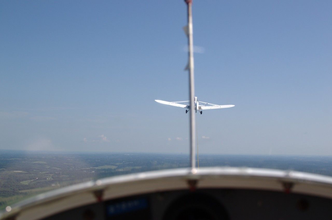 Looking out from the cockpit of a glider to see the towplane towing the glader