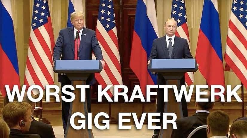 Trump and Putin are standing on a stage, looking at the audience. Behind them are the flags of Russia and the USA.