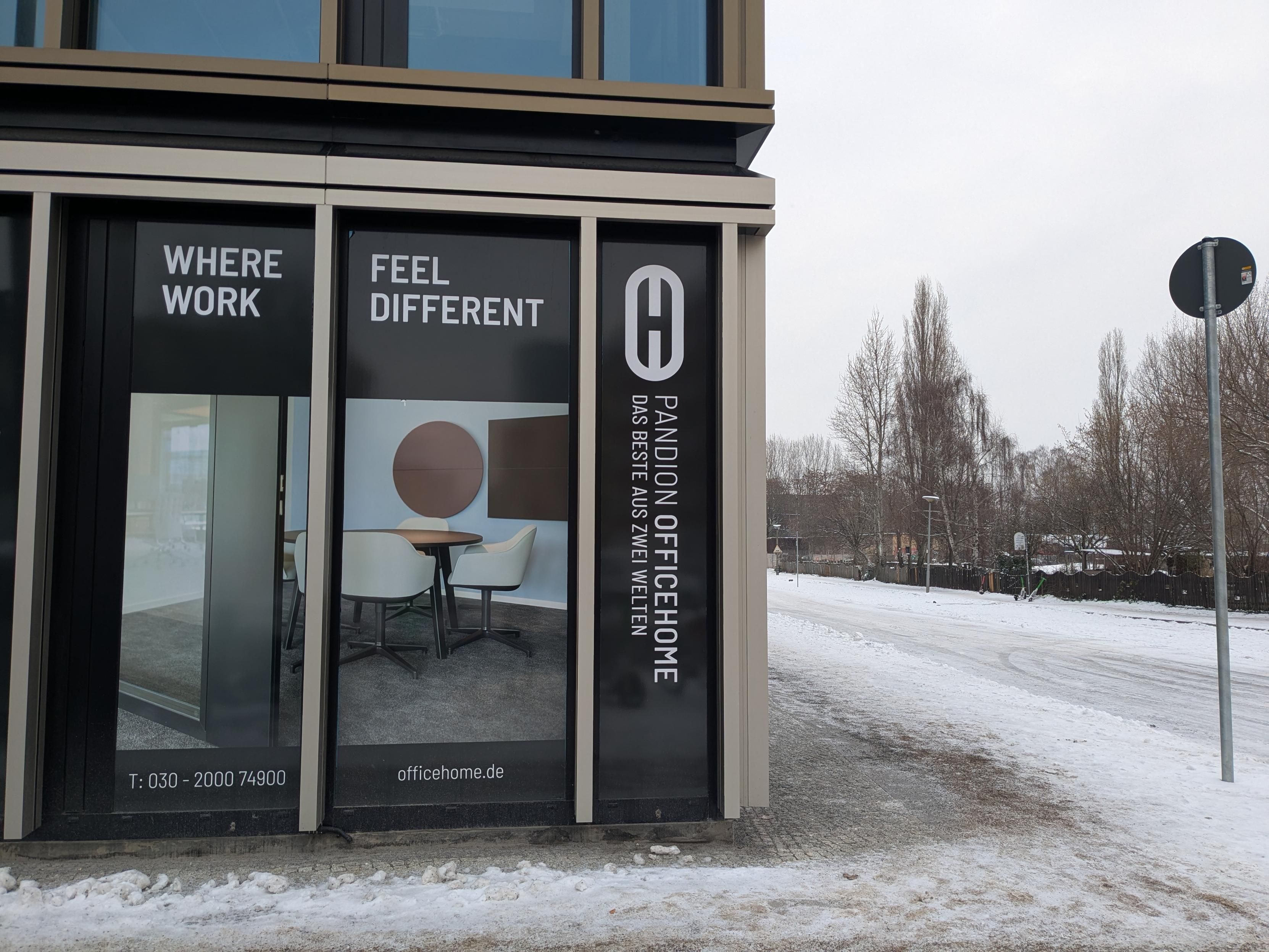 A photo of a corporate work hell building with a dumb sign 