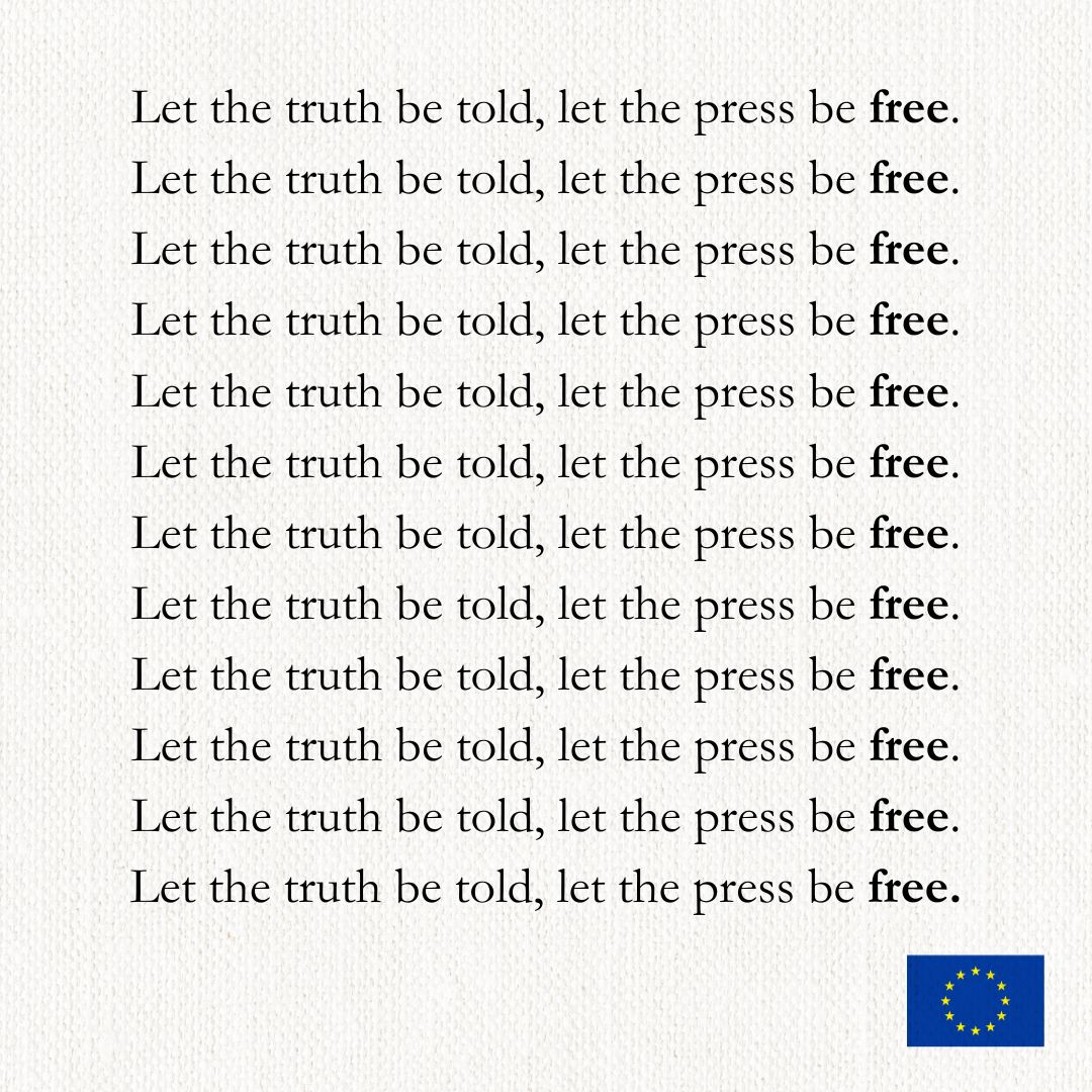 The image appears to feature a repeated text statement: "Let the truth be told, let the press be free." with the word "truth" and "free" emphasised in a different style bold and italic. At the bottom right, there is a symbol that resembles the European Union flag, suggesting the message is related to press freedom and transparency within or in relation to the EU. 