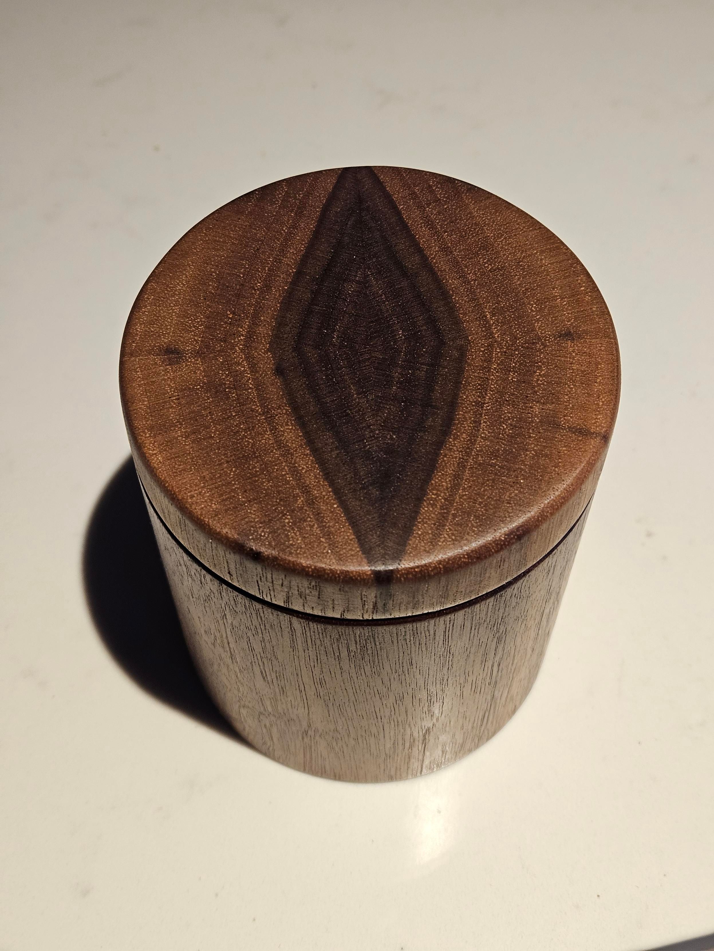 Picture of a walnut salt well I made 8n my garage workshop. The lid is made so the end grain pattern looks like a cat eye.