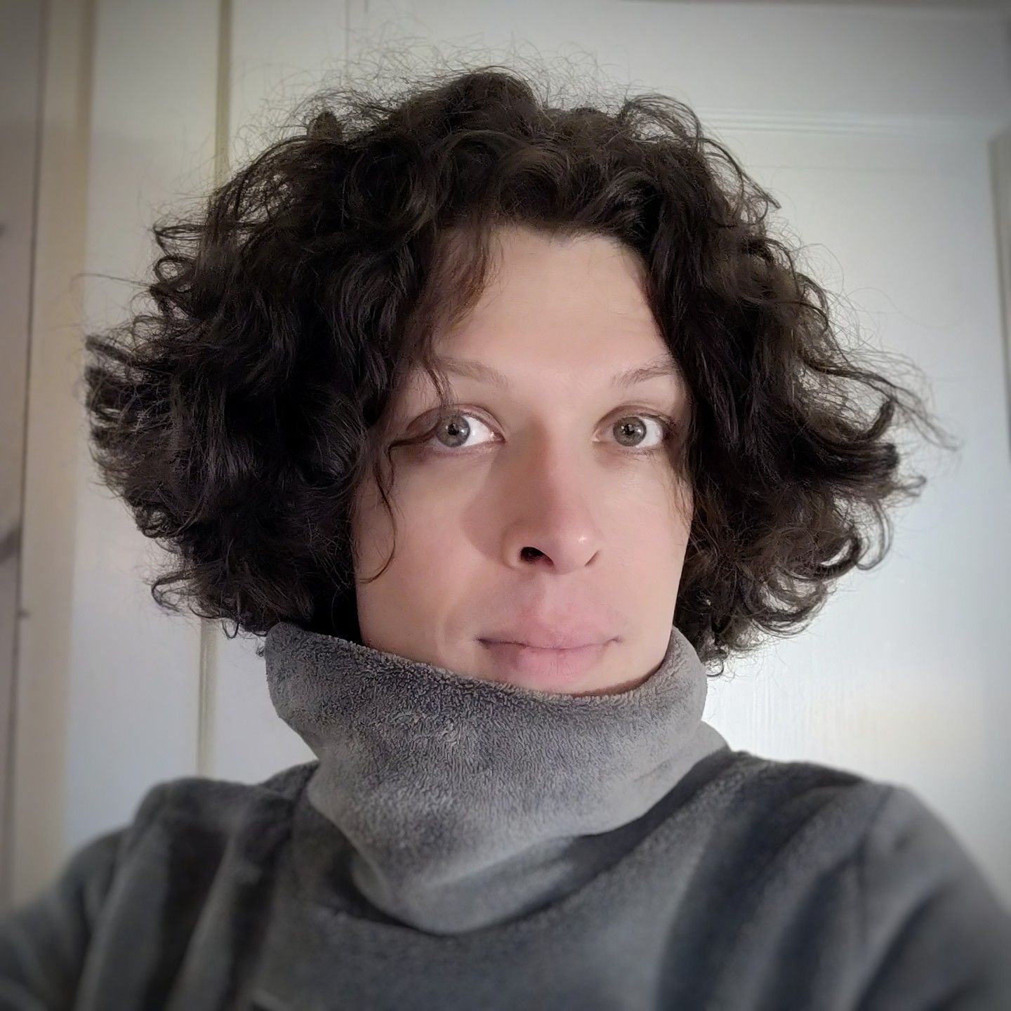 portrait selfie of me in a very thick sweater with a very high neck