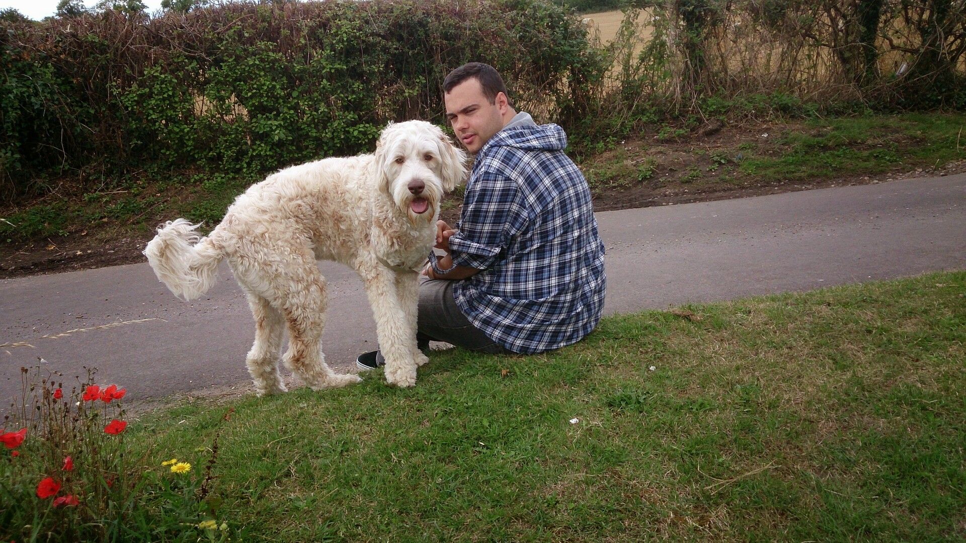 me and Erik sat together on a grass bank looking at the camera