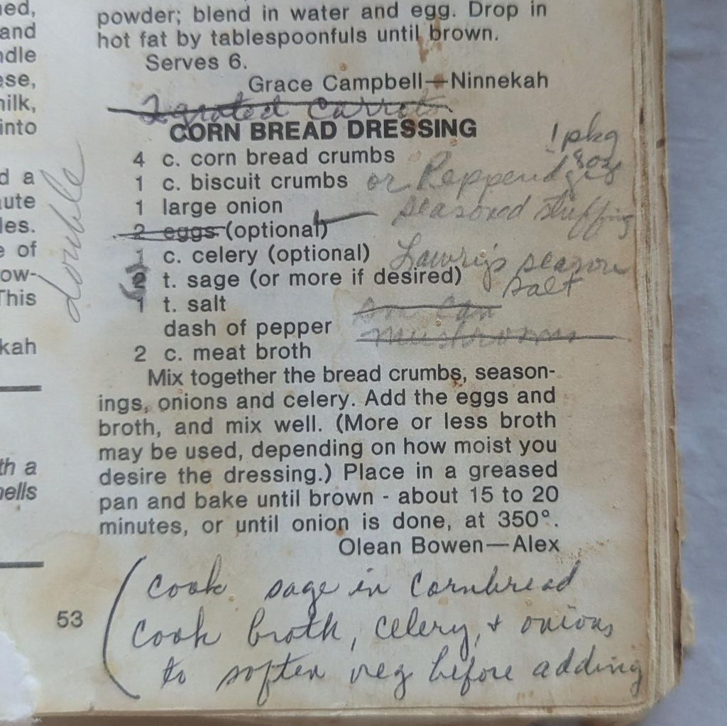 Cookbook page stained from use featuring a recipe for corn bread dressing with crossed-out words, ingredient adjustments, and cooking notes in pen, including instructions to cook onion, broth, and celery together.