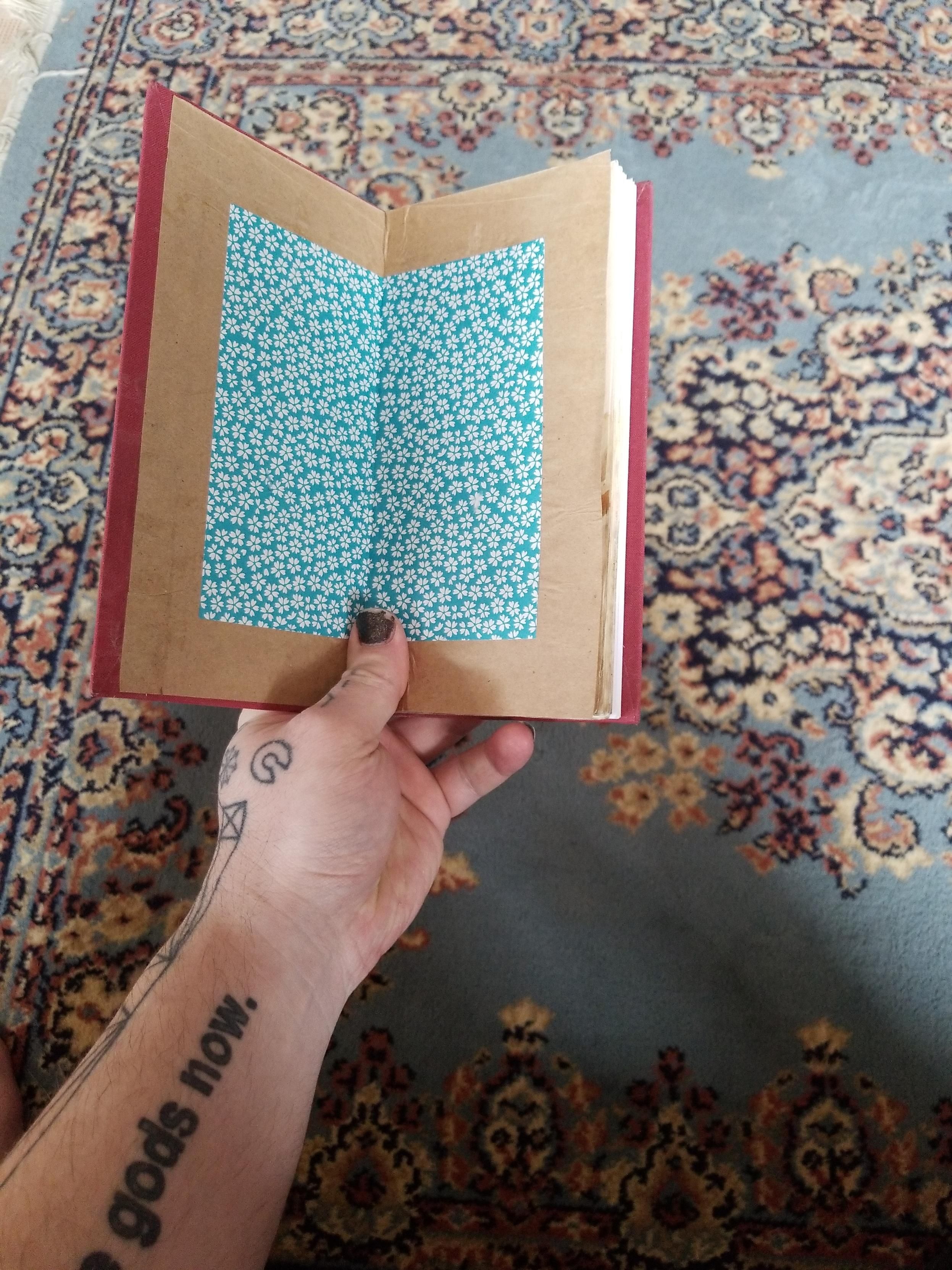 Lining of the journal made from brown craftpaper and flower-print origami paper