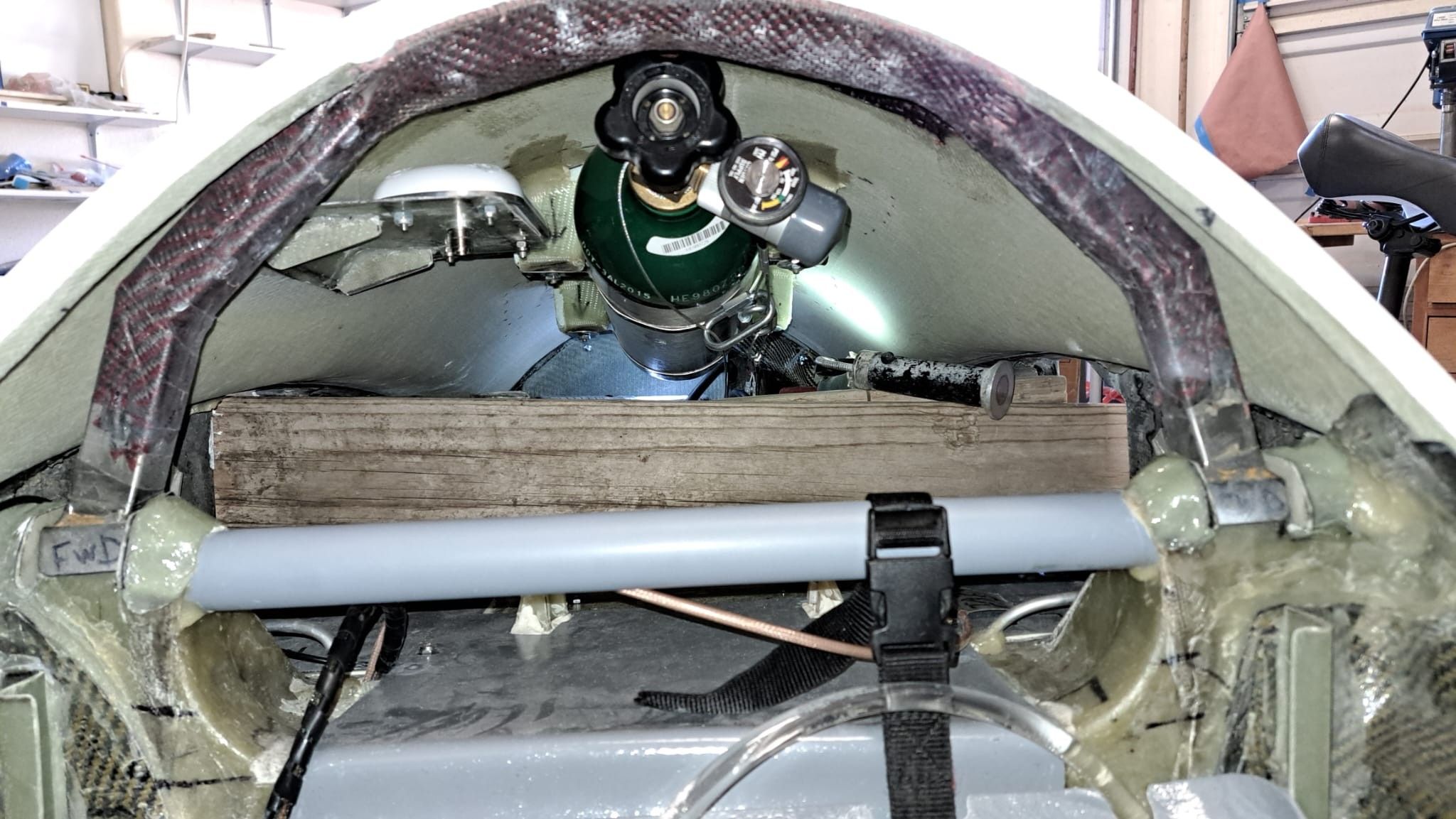 It's getting crowded under the turtle deck now that the oxygen tank has been installed. Note the wooden 2x4's that serve as mockups for the wing spars.