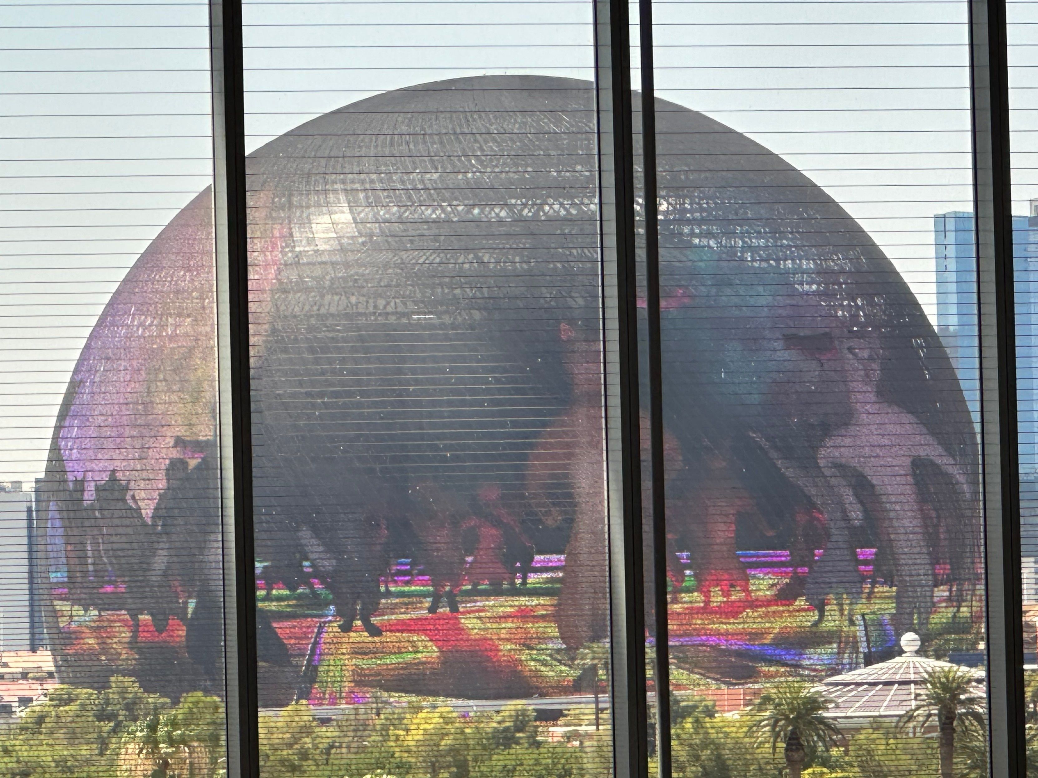 The Sphere in Las Vegas shown with a video of computer-generated dancing cats displayed over the surface on the building