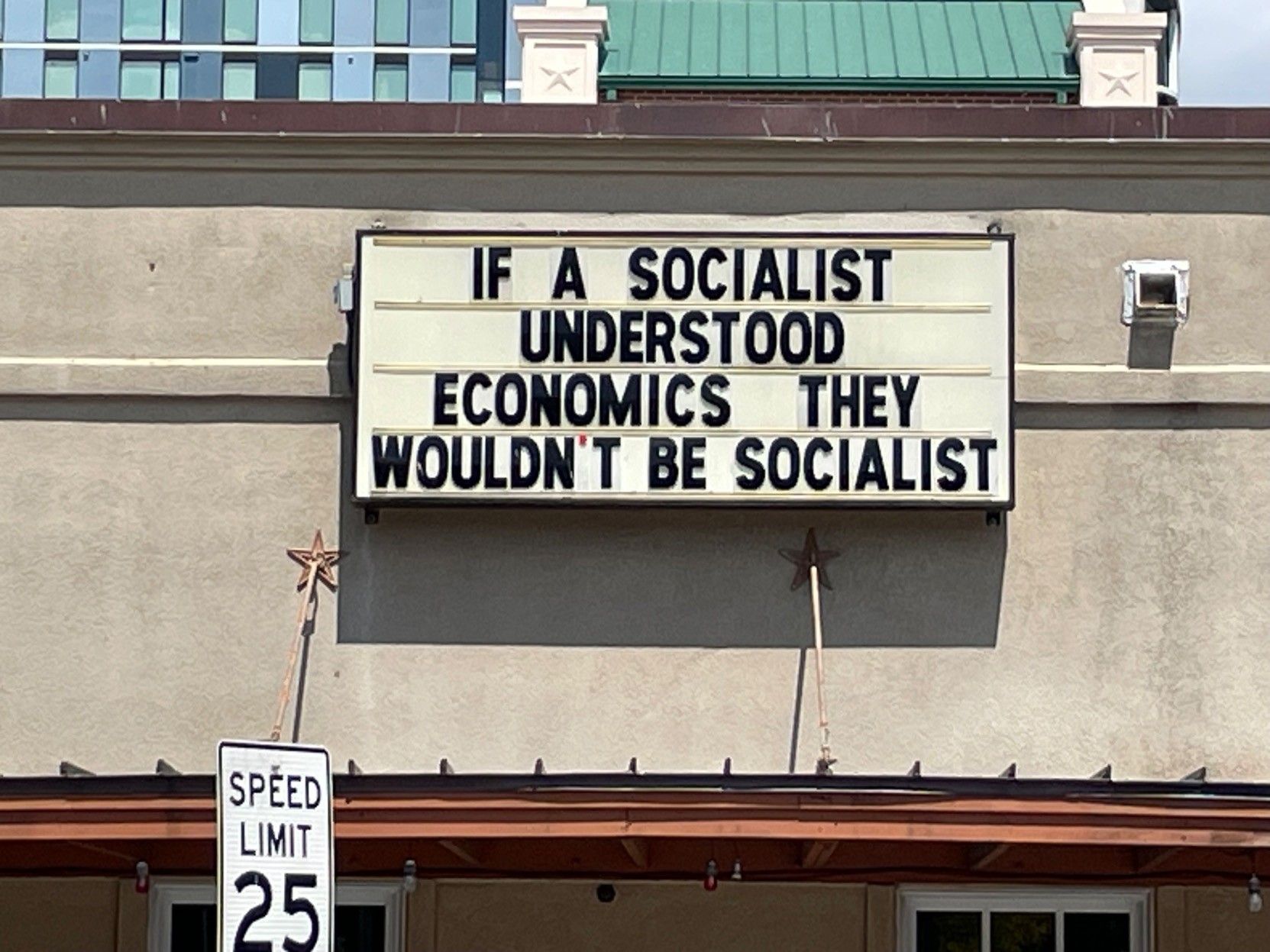 Marquee sign: “If a socialist understood economics, they wouldn’t be socialist”.  