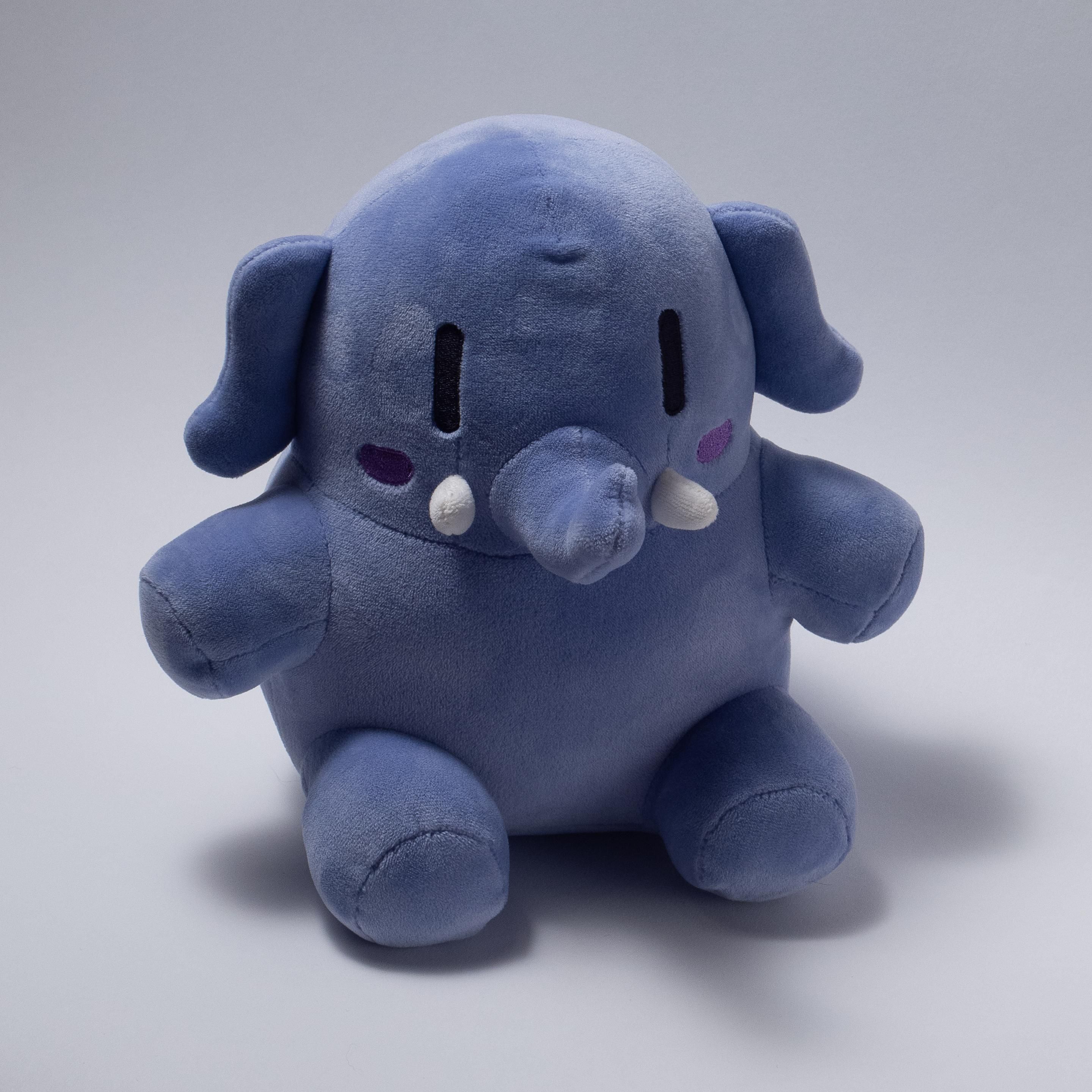 A blue stuffed Mastodon toy sitting comfortably.