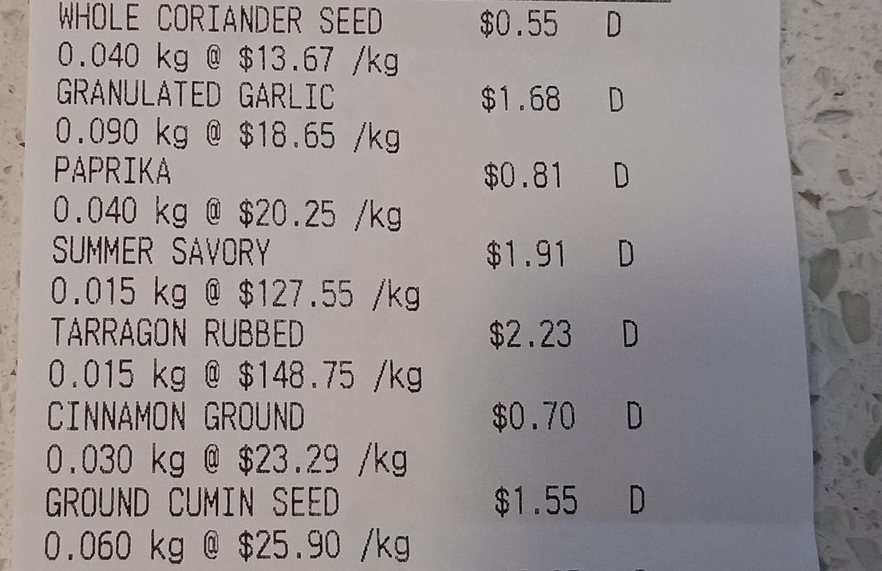 The receipt for the spices, each about a quarter cup in volume. Coriander is $.55 garlic is 1.68, paprika is .81, savory is 1.91, tarragon 2.23, cinnamon is .70, cumin is 1.55. 