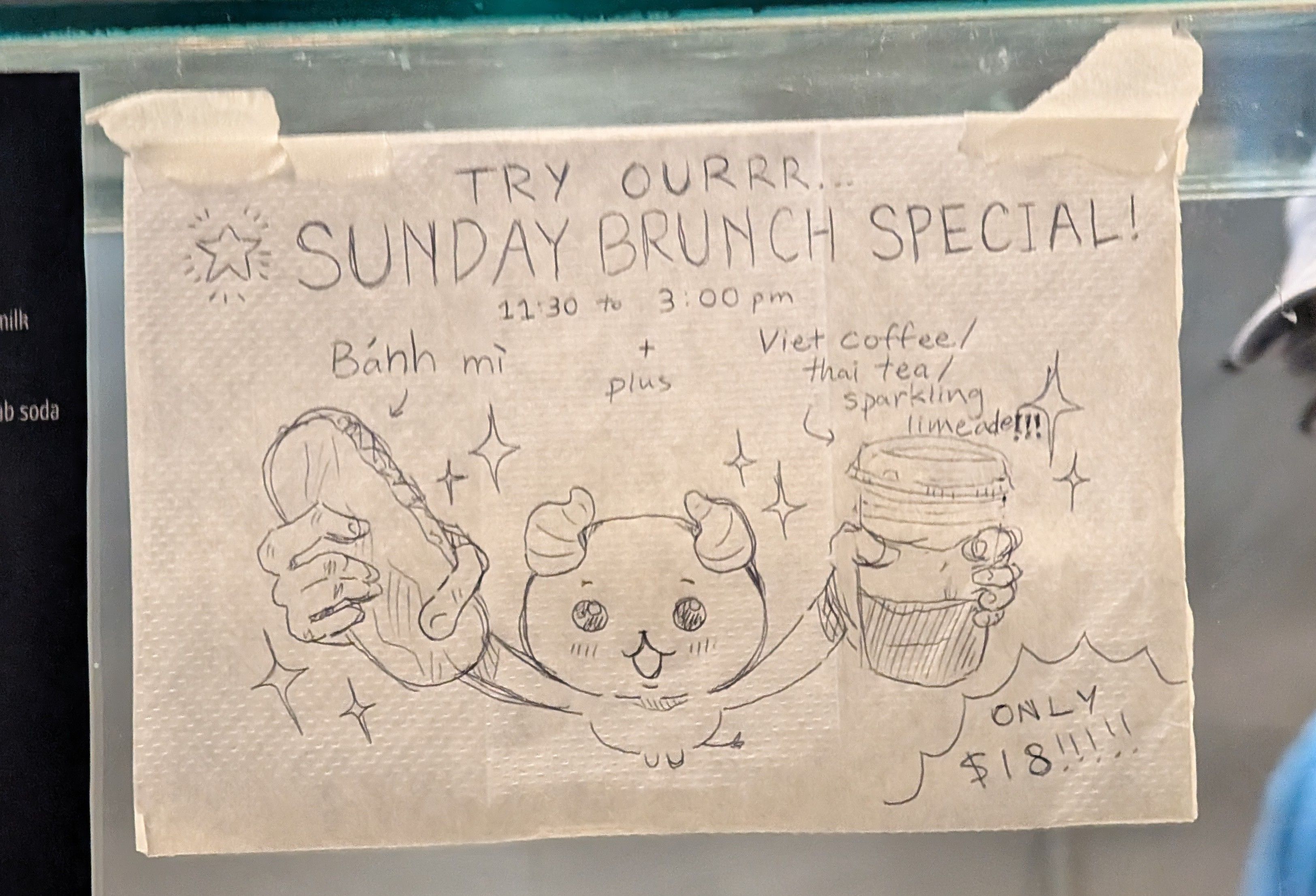 sketch of anime character on a napkin, holding a banh mi and a viet coffee cup, saying:

"try ourrr... SUNDAY BRUNCH SPECIAL! 11:30 to 3:00pm, Bánh mì plus Viet coffee / Thai tea / sparkling limeade!! ONLY $18!!!!!"