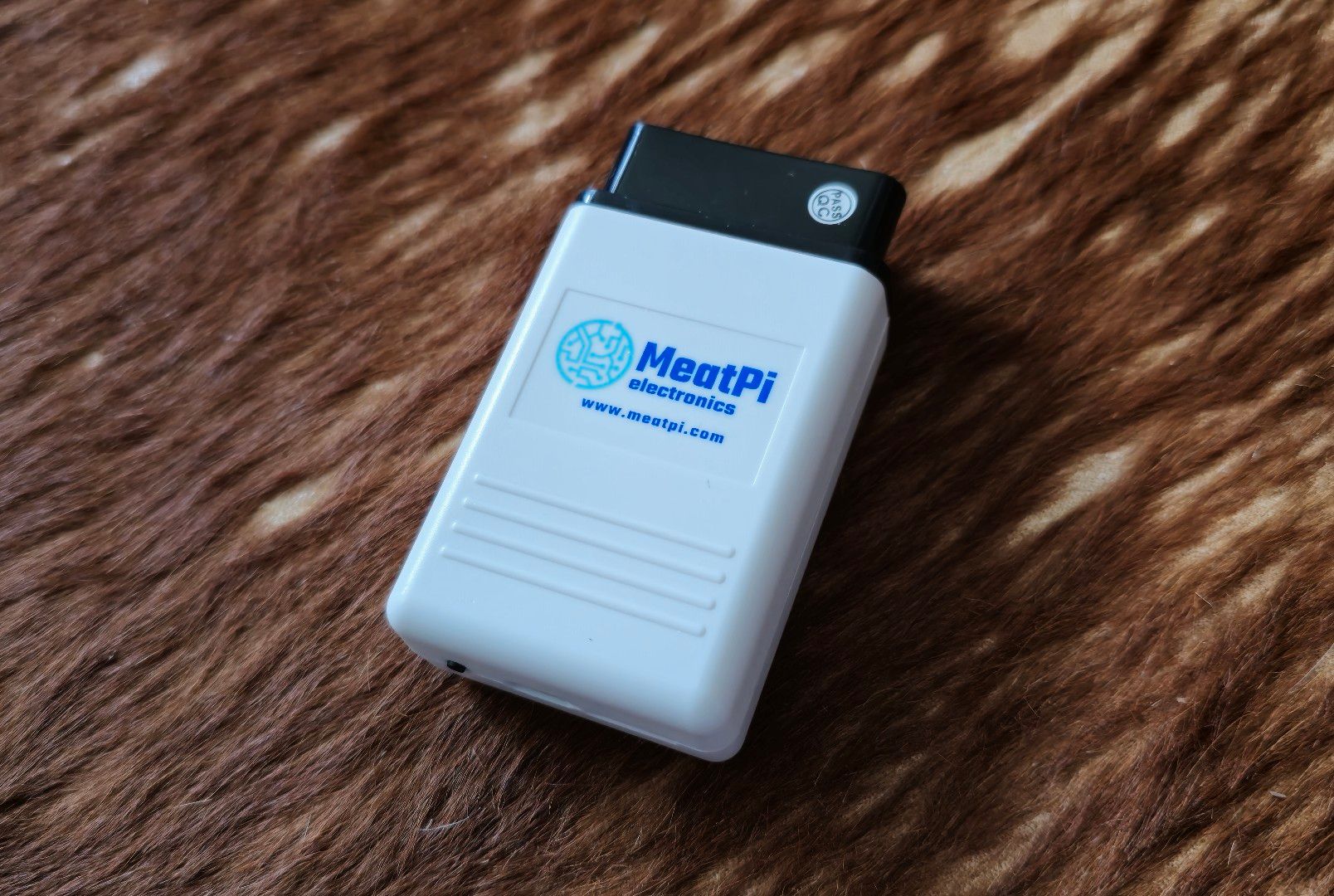 MeatPi Electronics auto diagnostic tool WiCAN PRO: device with white shell and black OBD-2 plug