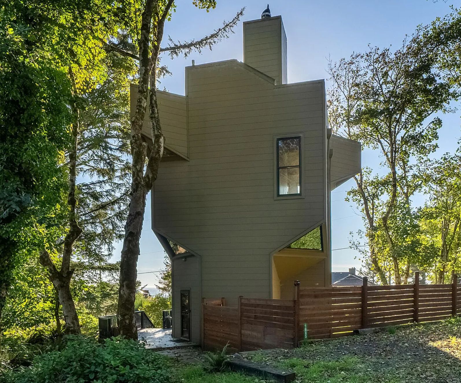 Another view of the same house from the side, which shows bits jutting out in different directions, the house is not particularly flat on any surface. 